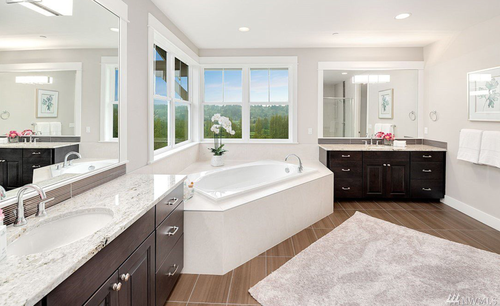 The master bath is complete with his and her’s vanities as well as a soaking tub looking out onto the protected wetlands!