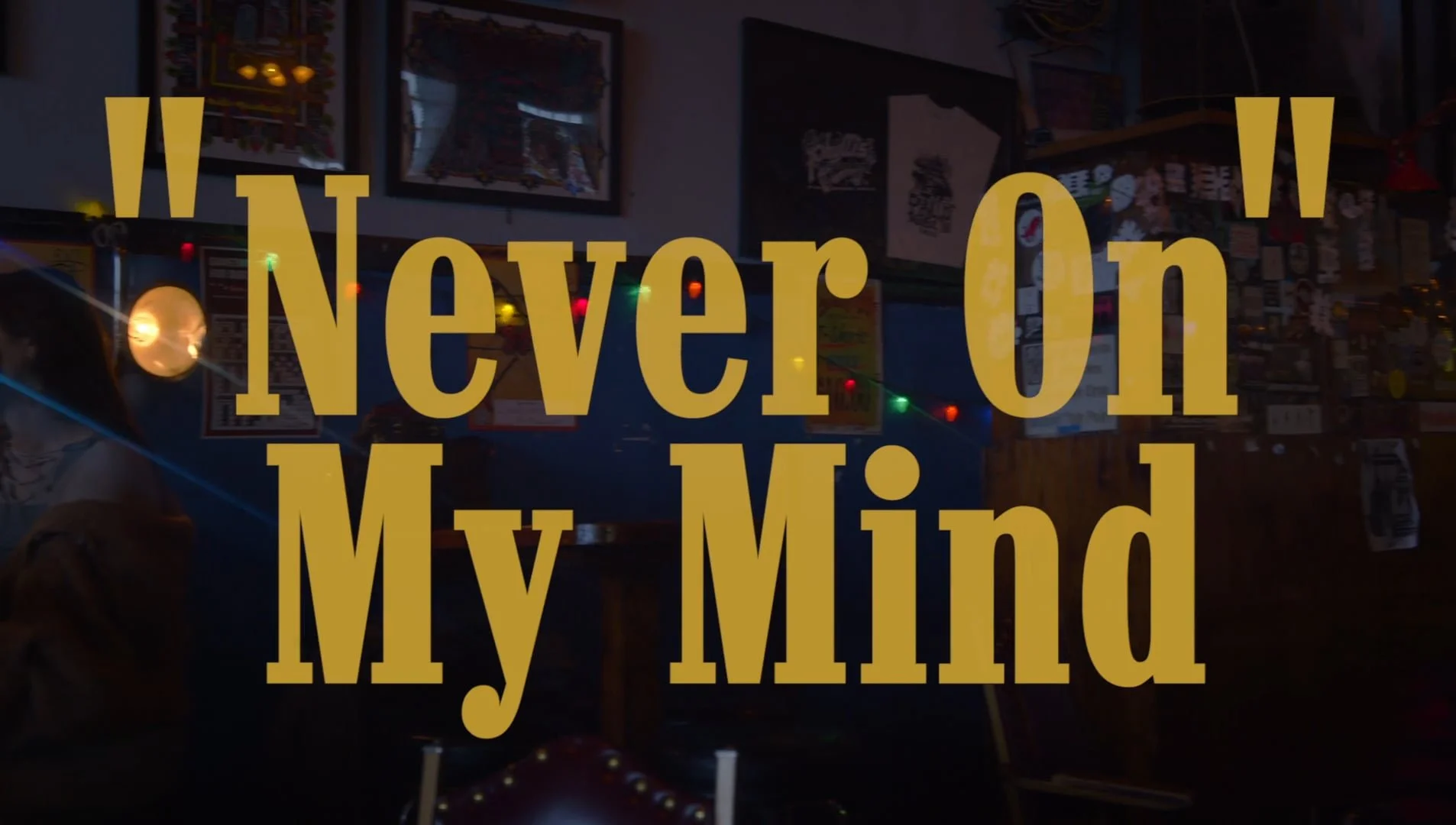 Text on a dark background reading 'Never On My Mind' in large yellow font.
