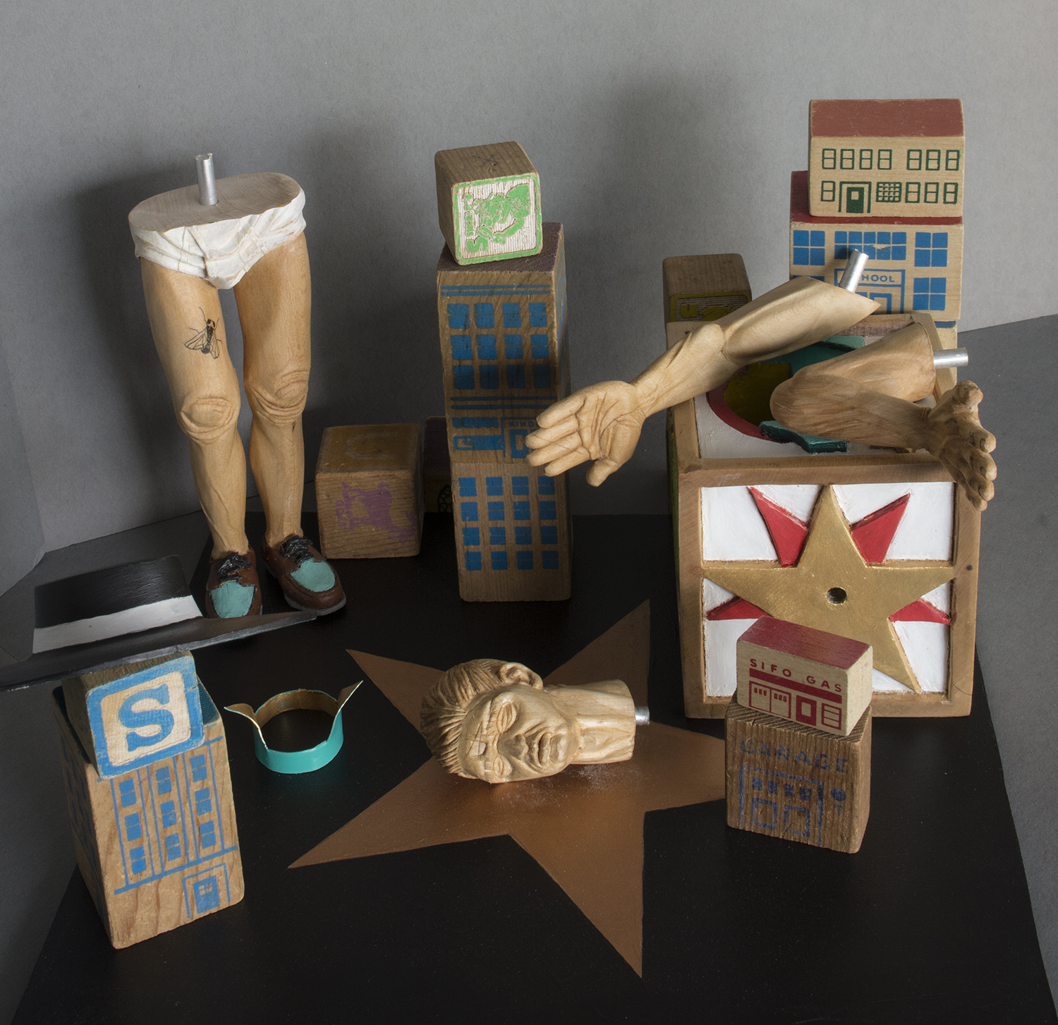 Each piece was carved separately, and is joined with an aluminum rod. The arms, legs, head and collar are all moveable. The antique toy blocks are loose, and can be rearranged.