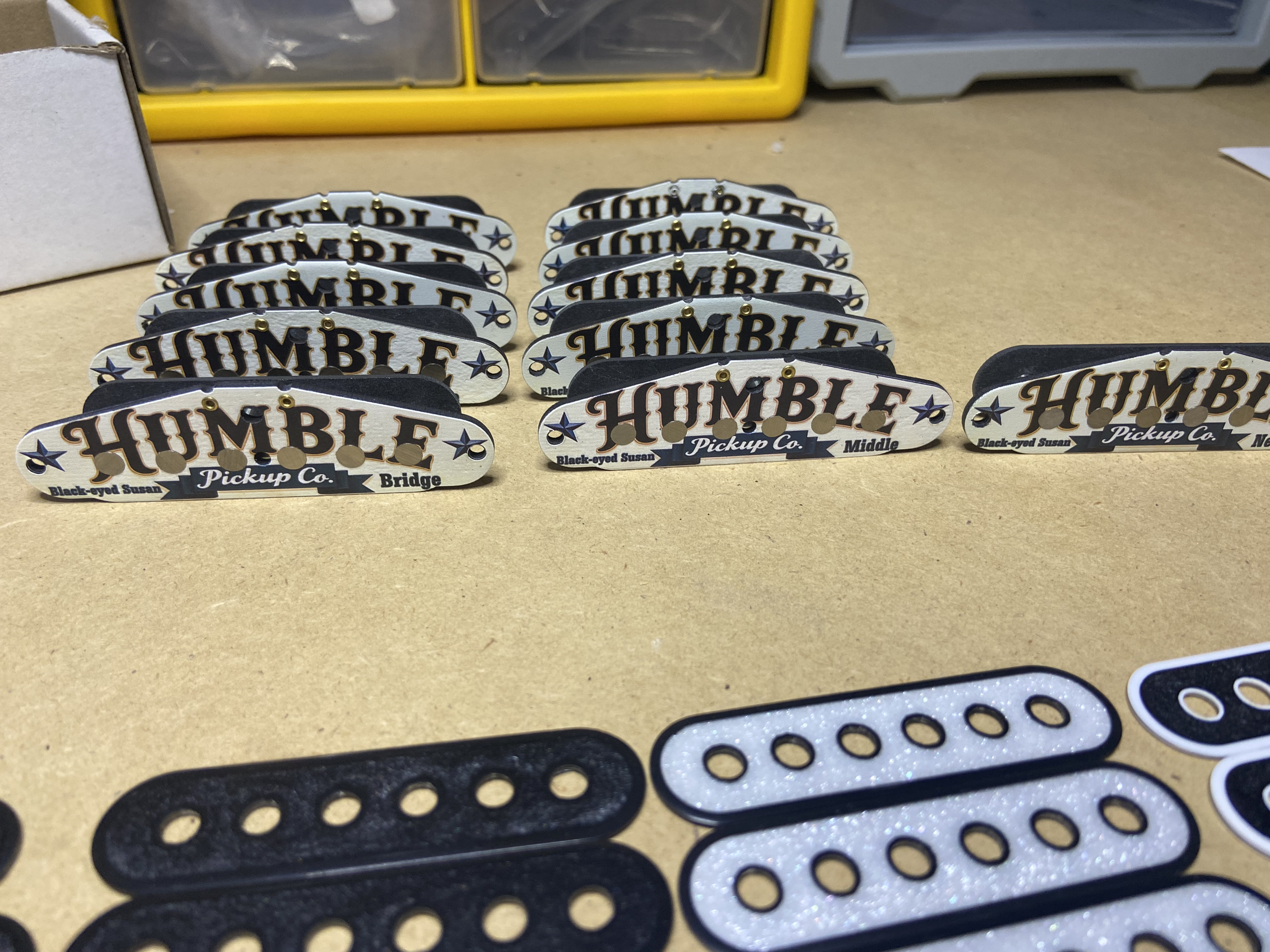 Multiple bumper stickers with the word 'HUMBLE' in bold, black font, arranged in rows on a flat surface, some adhesive residue on the back.