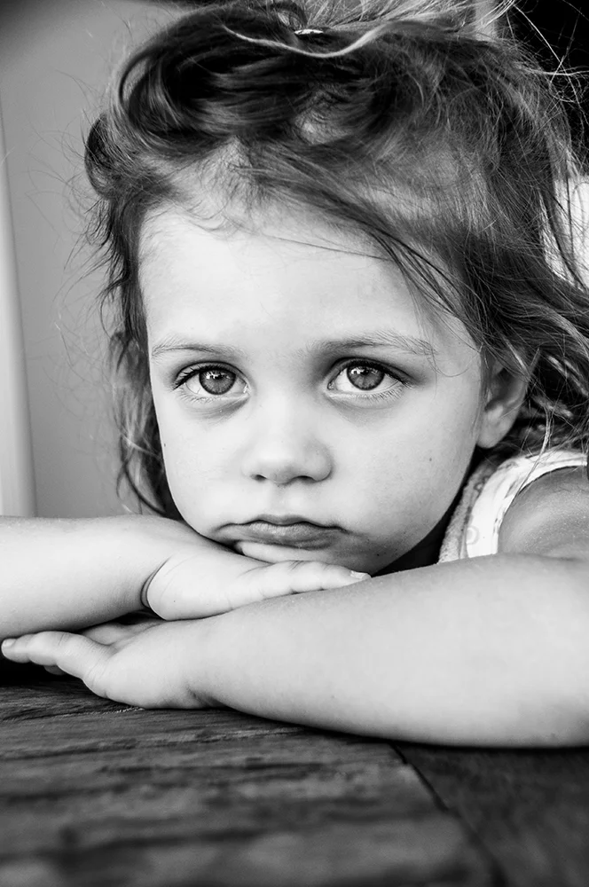 Lila Leaning on Table Website.jpg