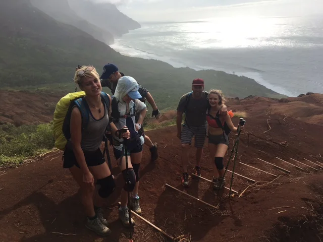 A group of tourists hiking in Kauai