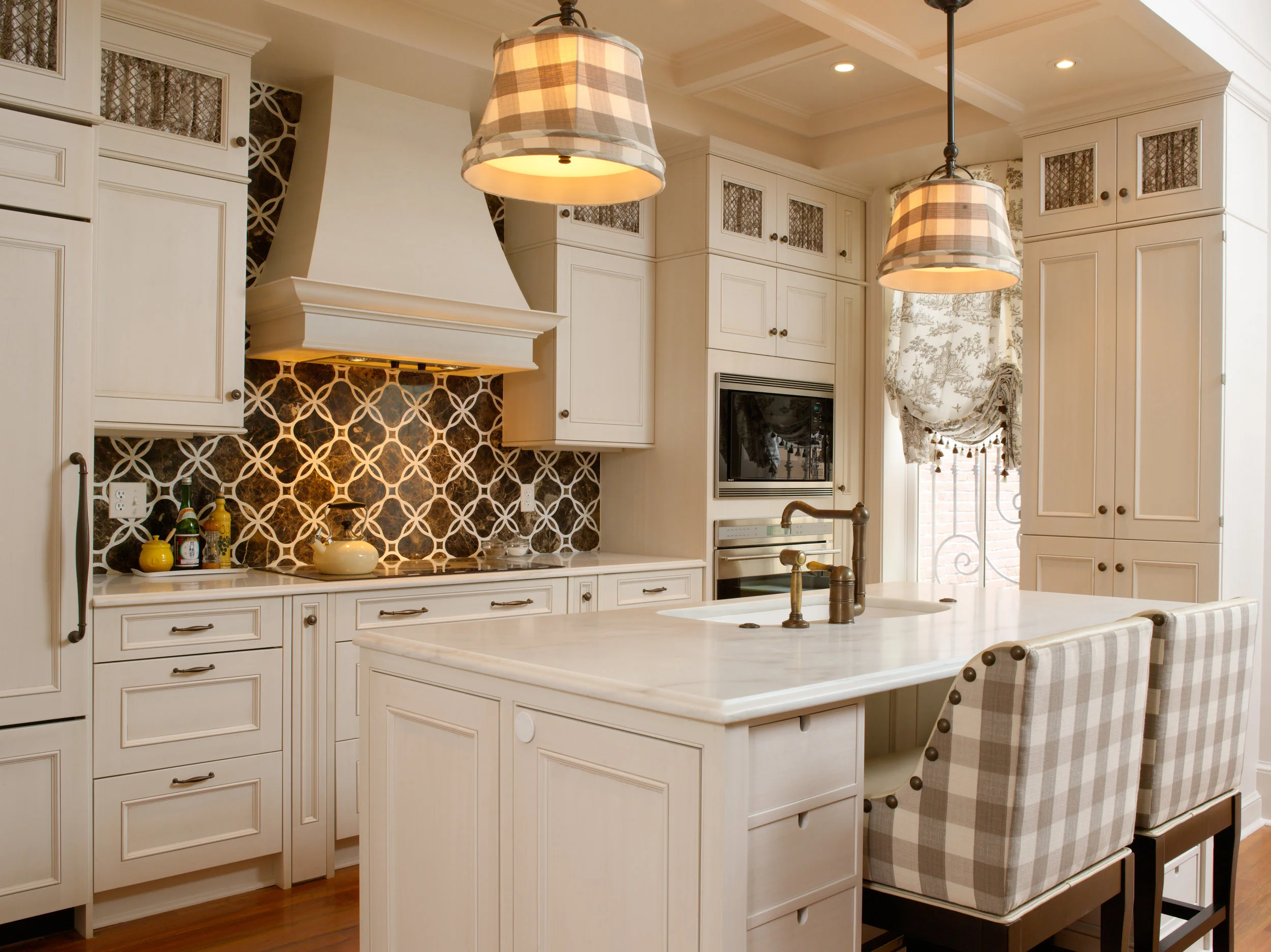Kitchen with gingham details in the bar stools and fabric pendant shades.