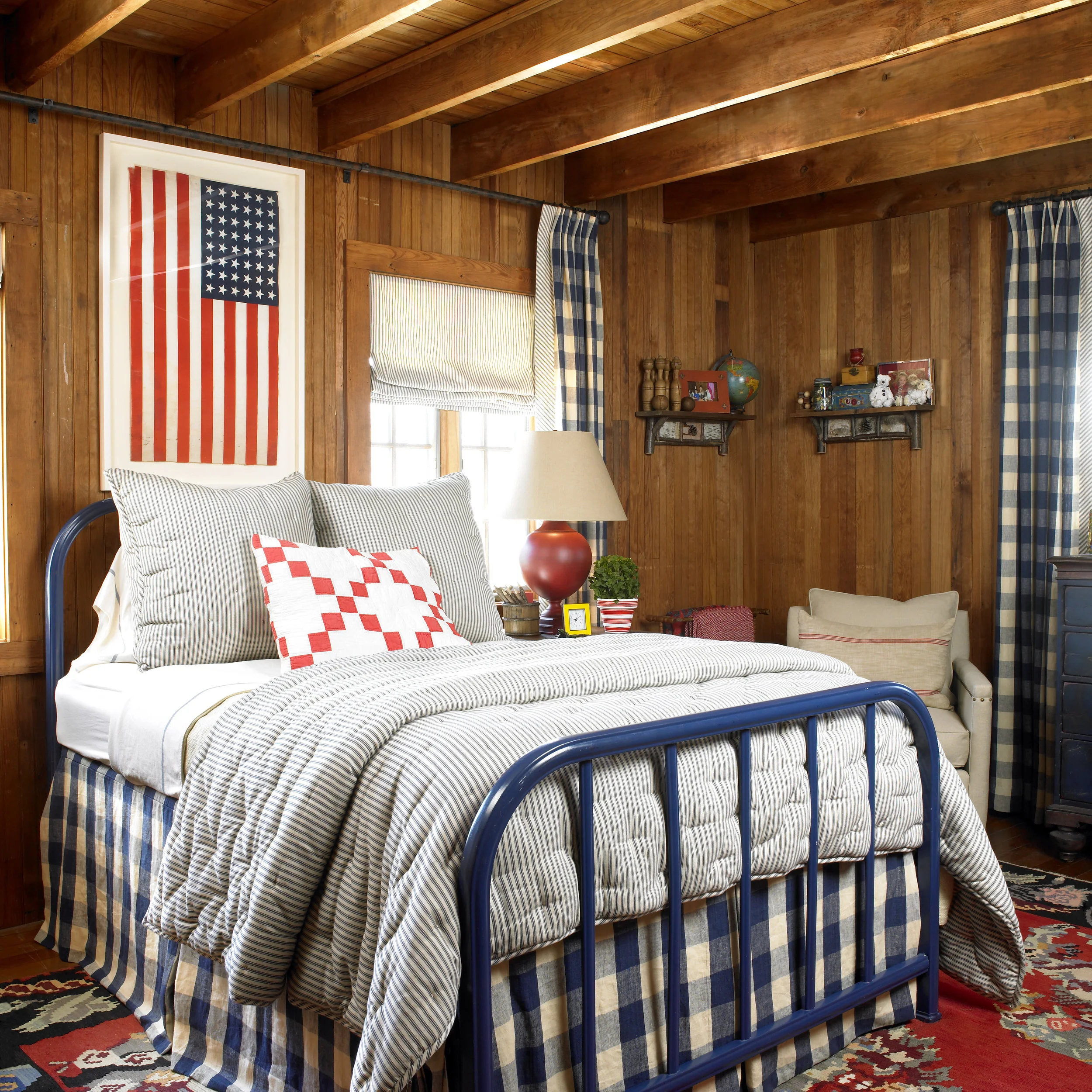 True Americana feel in this cozy bedroom with the royal blue gingham drapes and bed skirt.