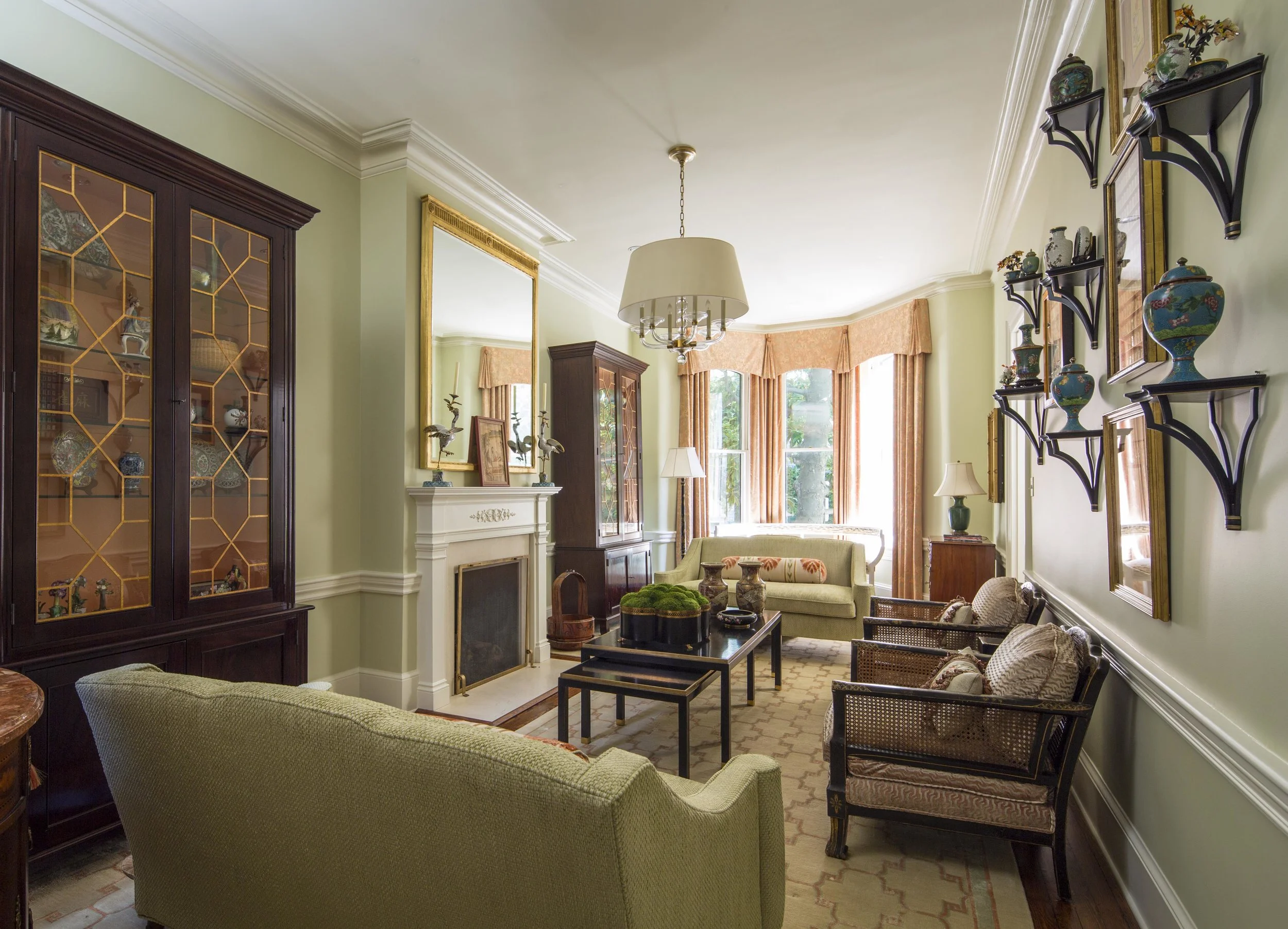 In this living room, the coral is paired with a soft green and it is nothing short of elegance. We even painted the interior of these cabinets a shade of this soft coral.