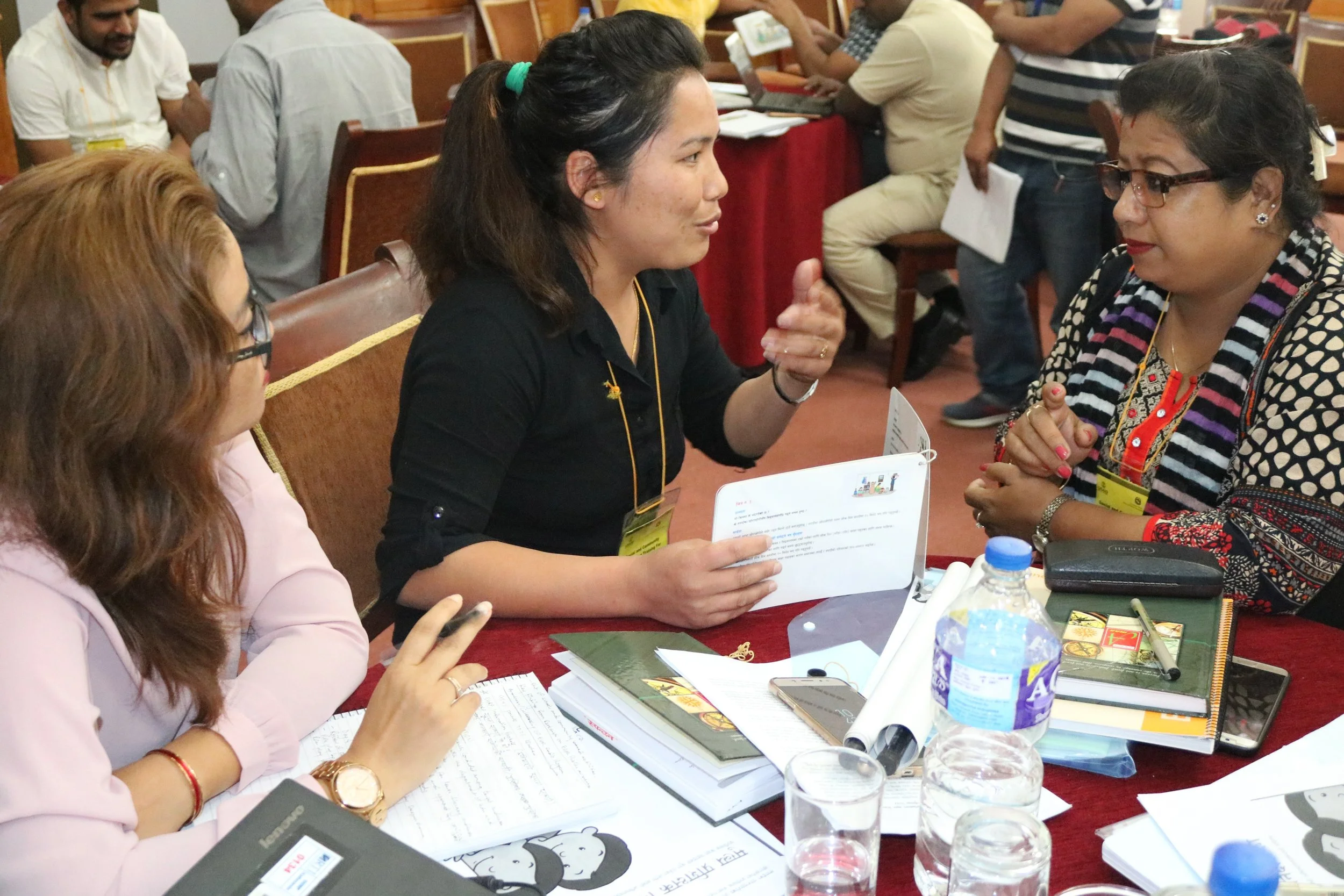Participants in an Another Option-led training role-playing on social mobilization techniques for early grade reading during a national training in Katmandu, Nepal.