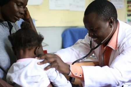 An AAH health provider meets with a family during regular clinic hours at the NGO’s health facility in Uganda.