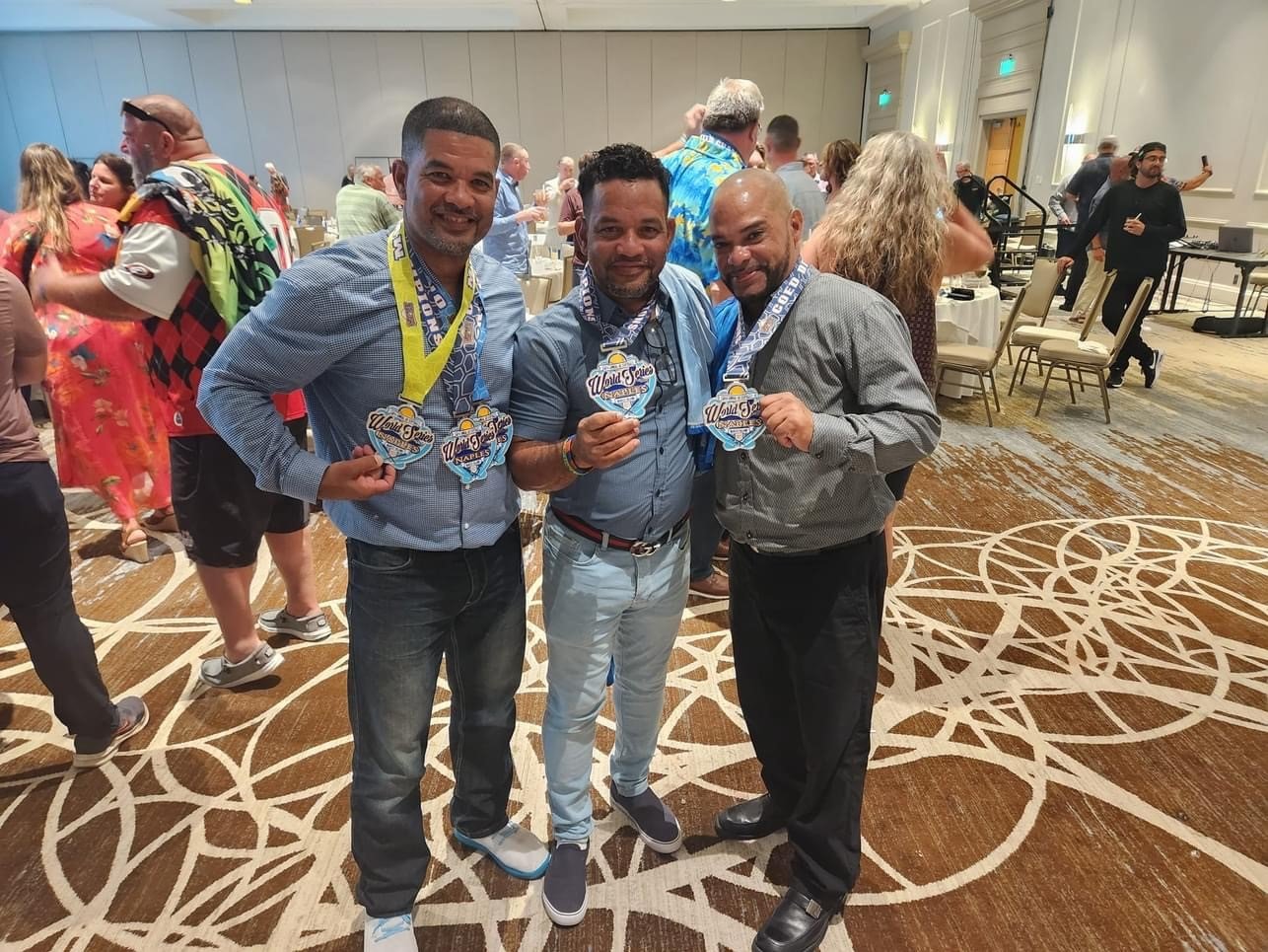 Cocktails - Los - Victor, Odalis, Eli Serrano at banquet wearing medals.jpg