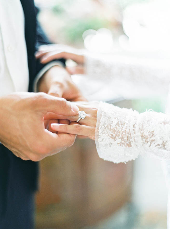 A bride and groom exchanging wedding rings at a French chateau.