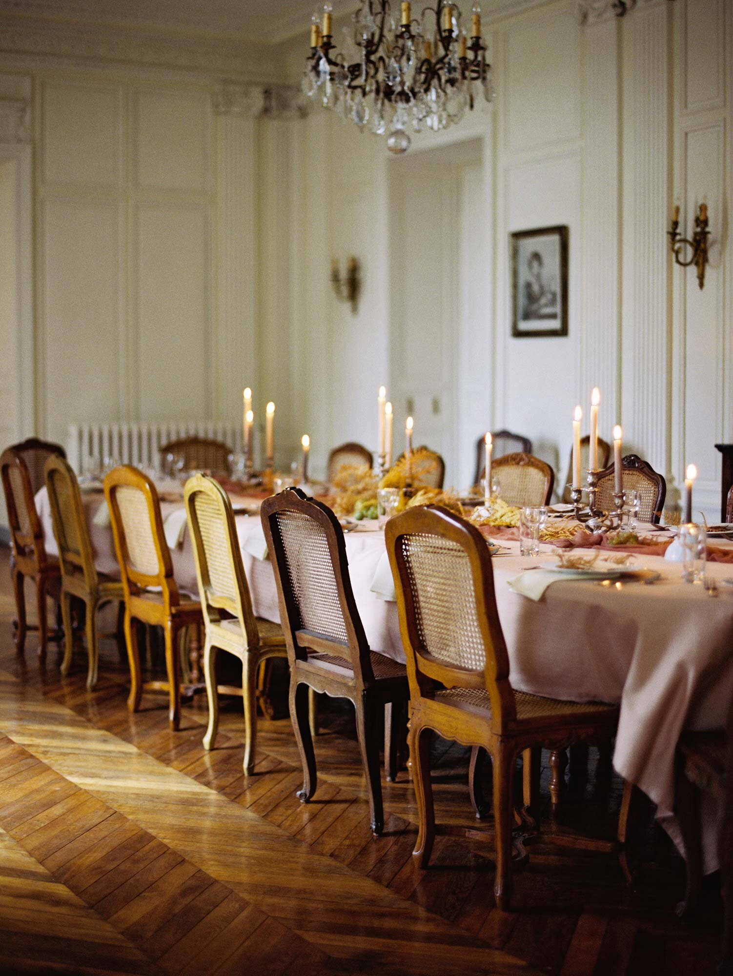 A long dining table decorated ready for a meal during a workshop in the dining room at Chateau de Courtomer.