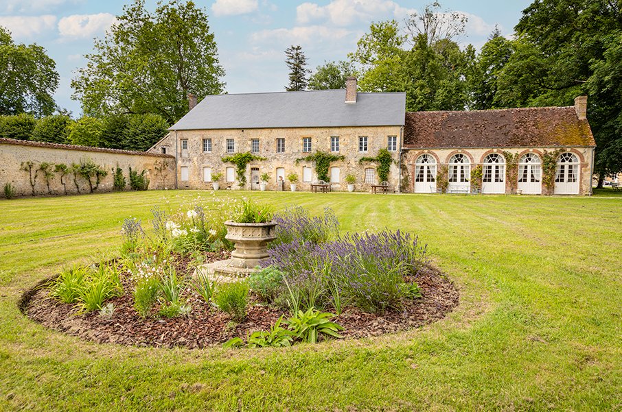 The Orangerie on the Courtomer estate, opening onto extensive lawns, available for rent in Normandy.