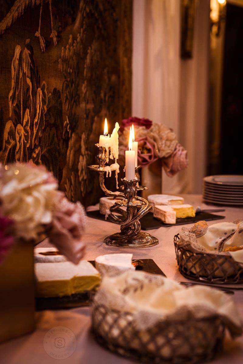A table setting decorated with candles, beautiful flowesr and local cheese; perfect indulgence for a weekend getaway in France.