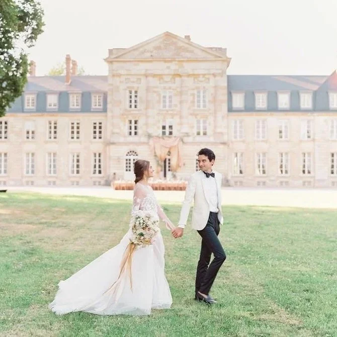 Bride and Groom Standing in front of Chateau de Courtomer on their wedding day