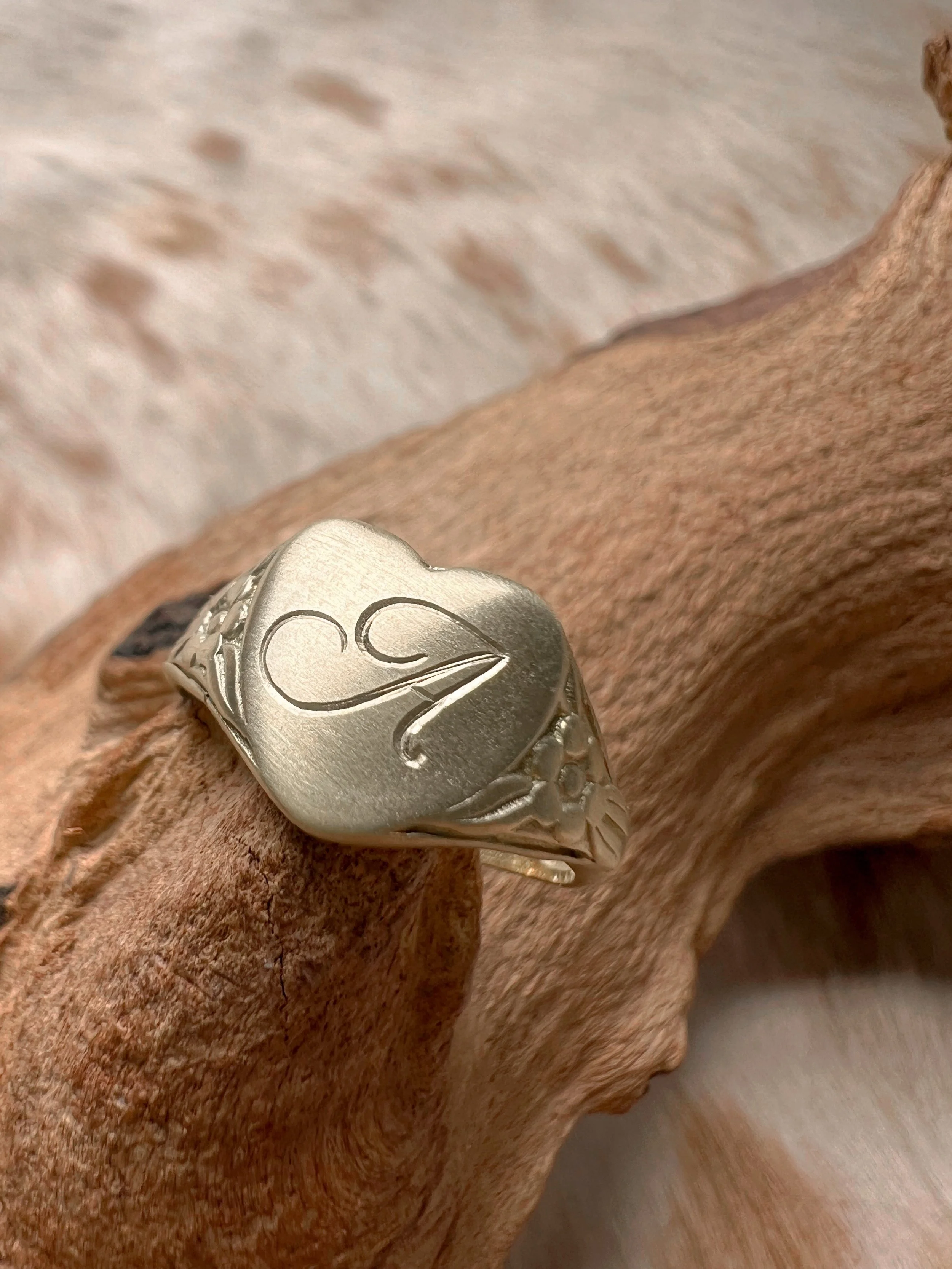 Personalized heart shaped brass signet ring with a custom script letter