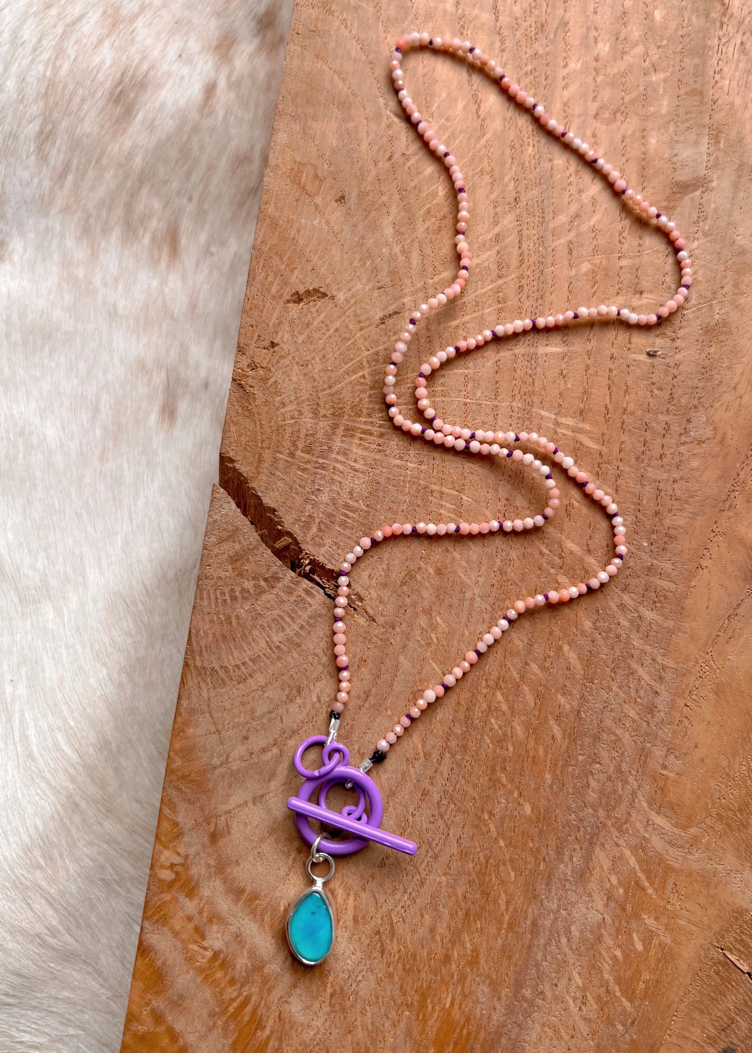 pink opal beaded necklace with a center turquoise pendant