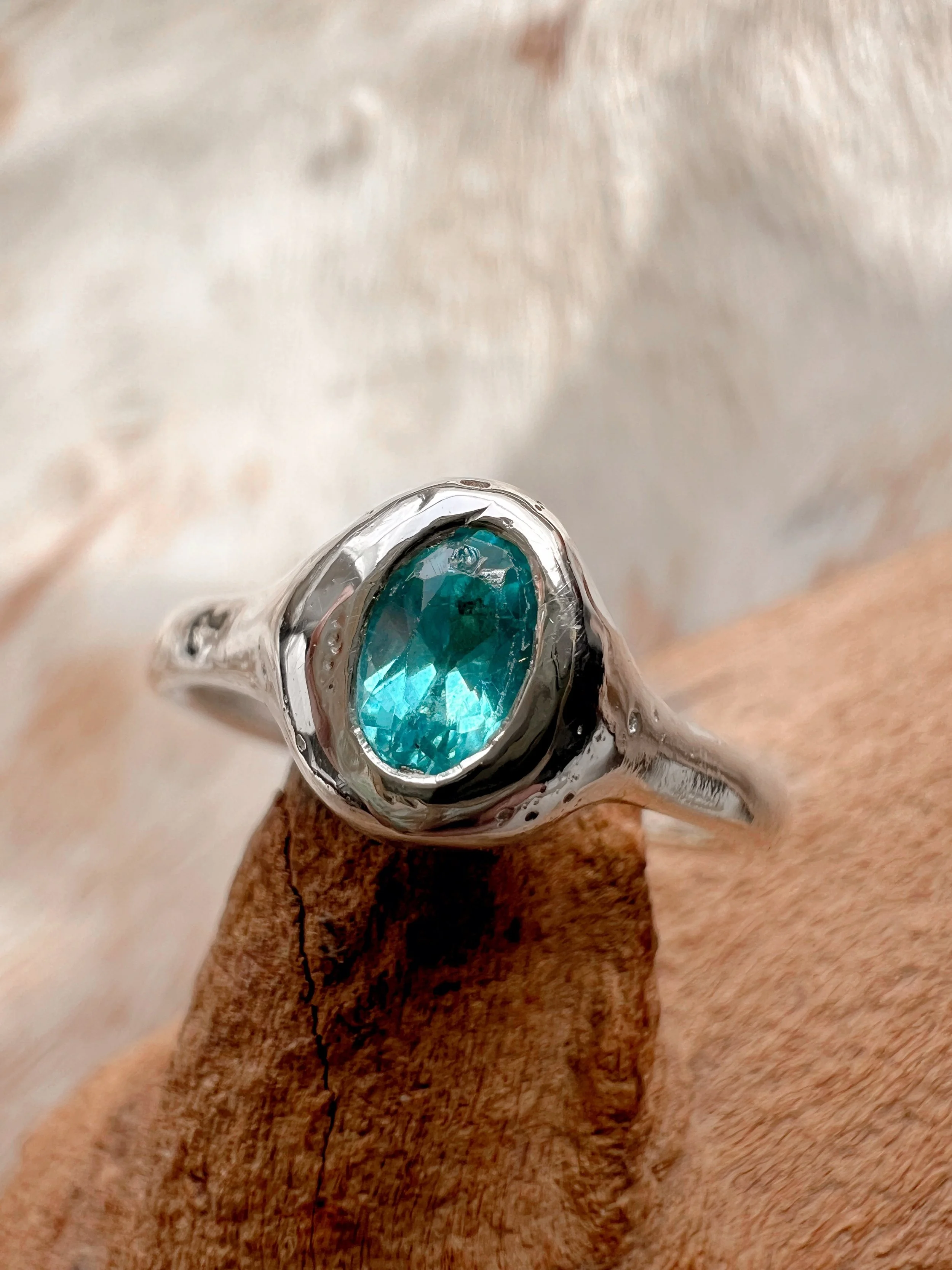 Signet-style sterling silver ring with a subtle, hand-carved texture and topped with a blue Apatite