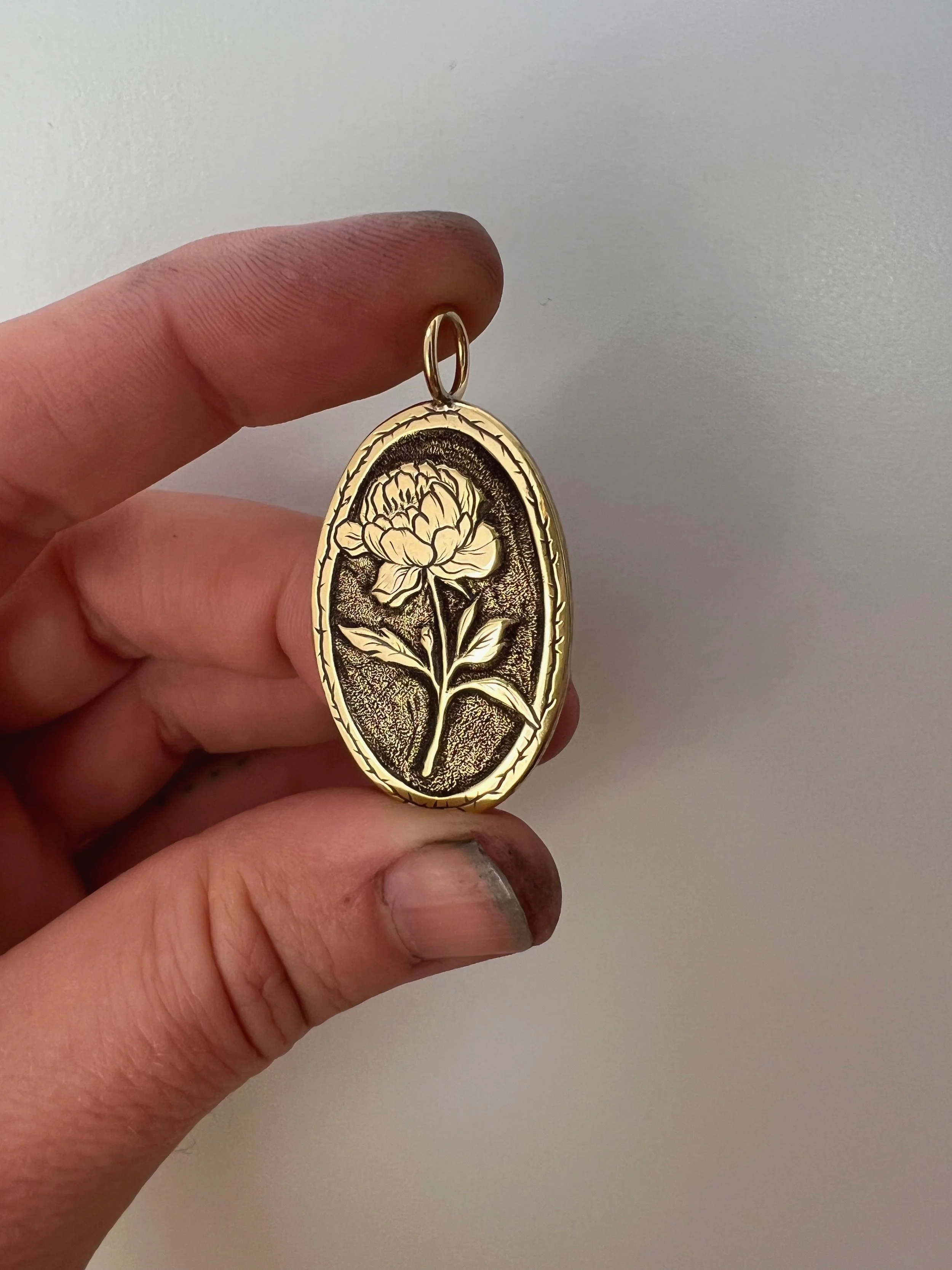 Band engraved, brass pendant featuring peony flower