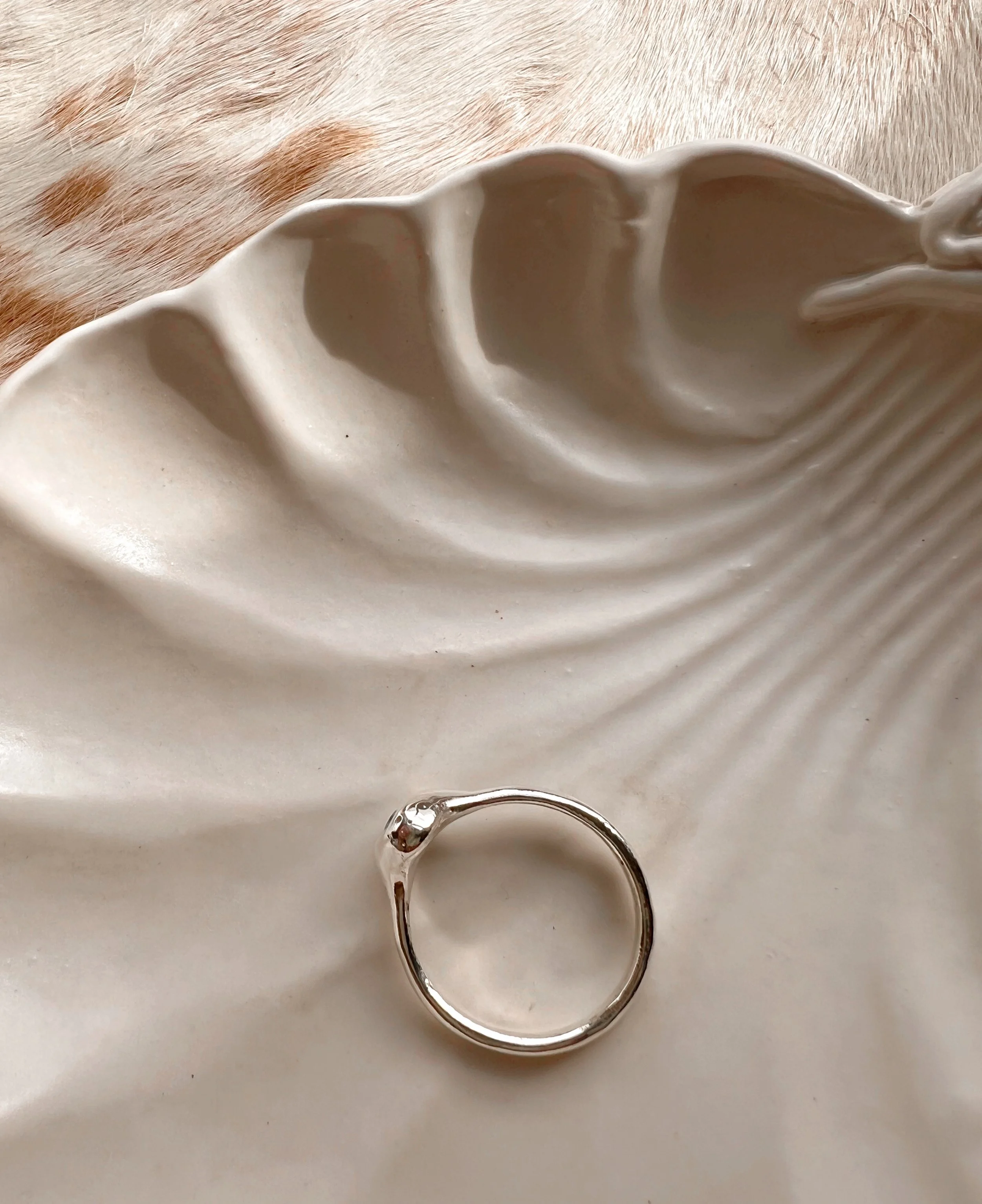 Signet-style sterling silver ring with a subtle, hand-carved texture and topped with a blue Apatite