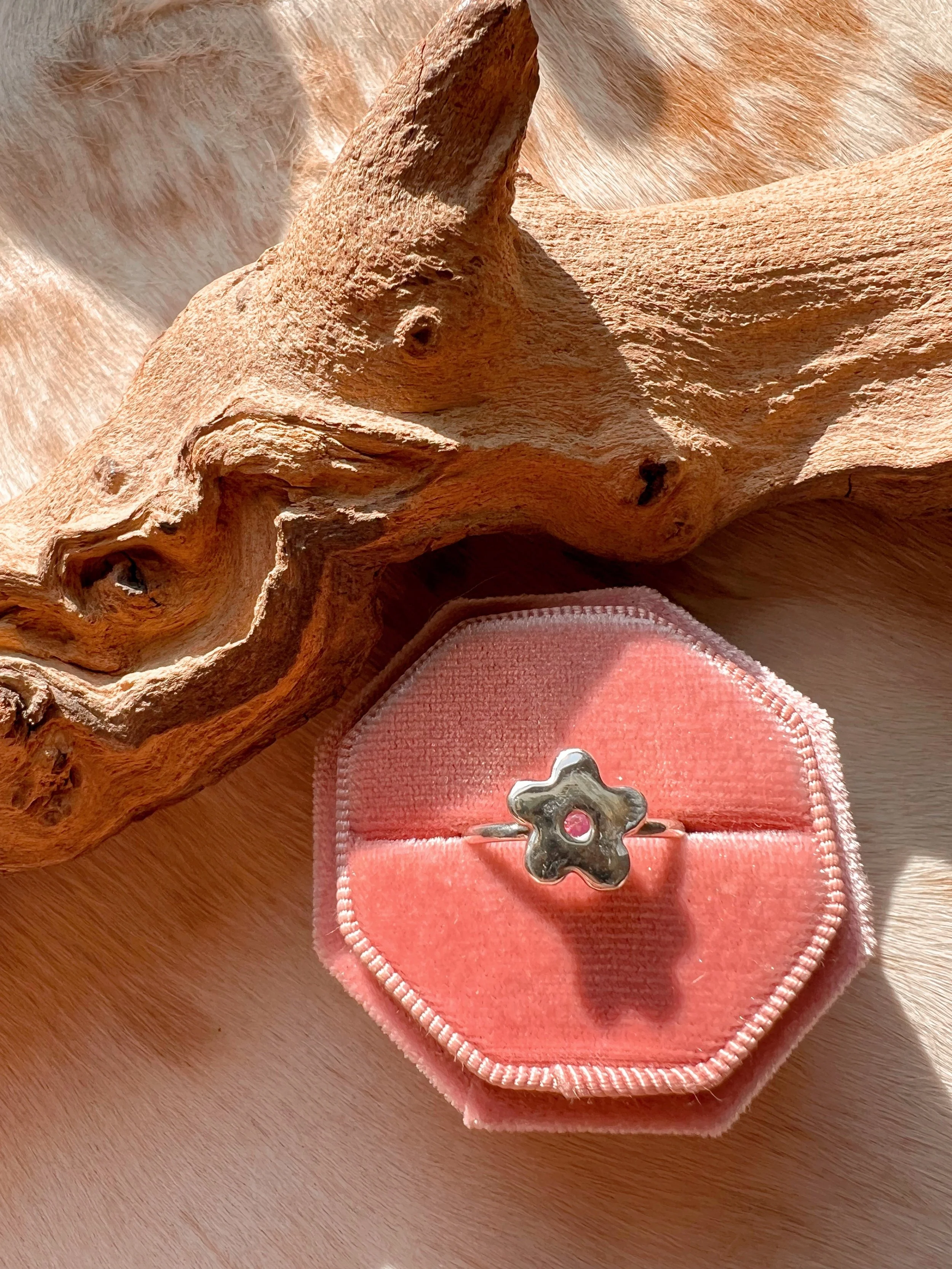 Pink Sapphire center set in a sterling silver flower , ring