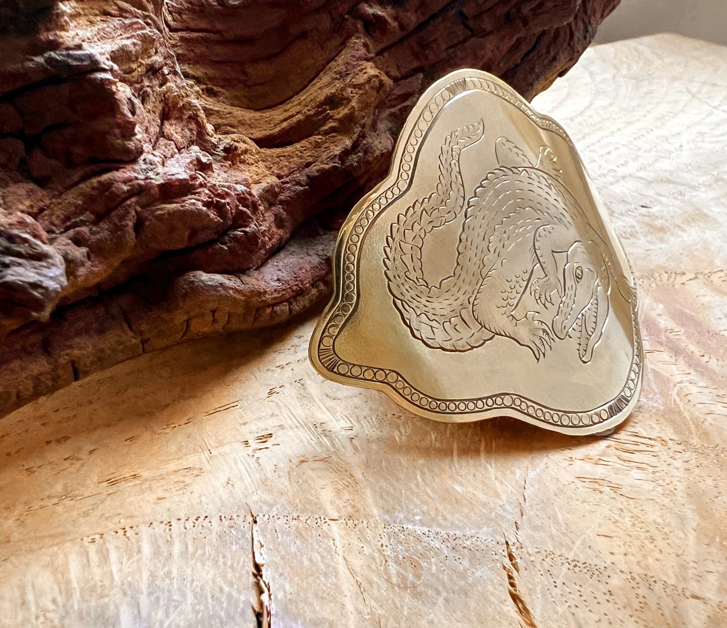 One-of-a-kind hand-engraved brass slide featuring an alligator