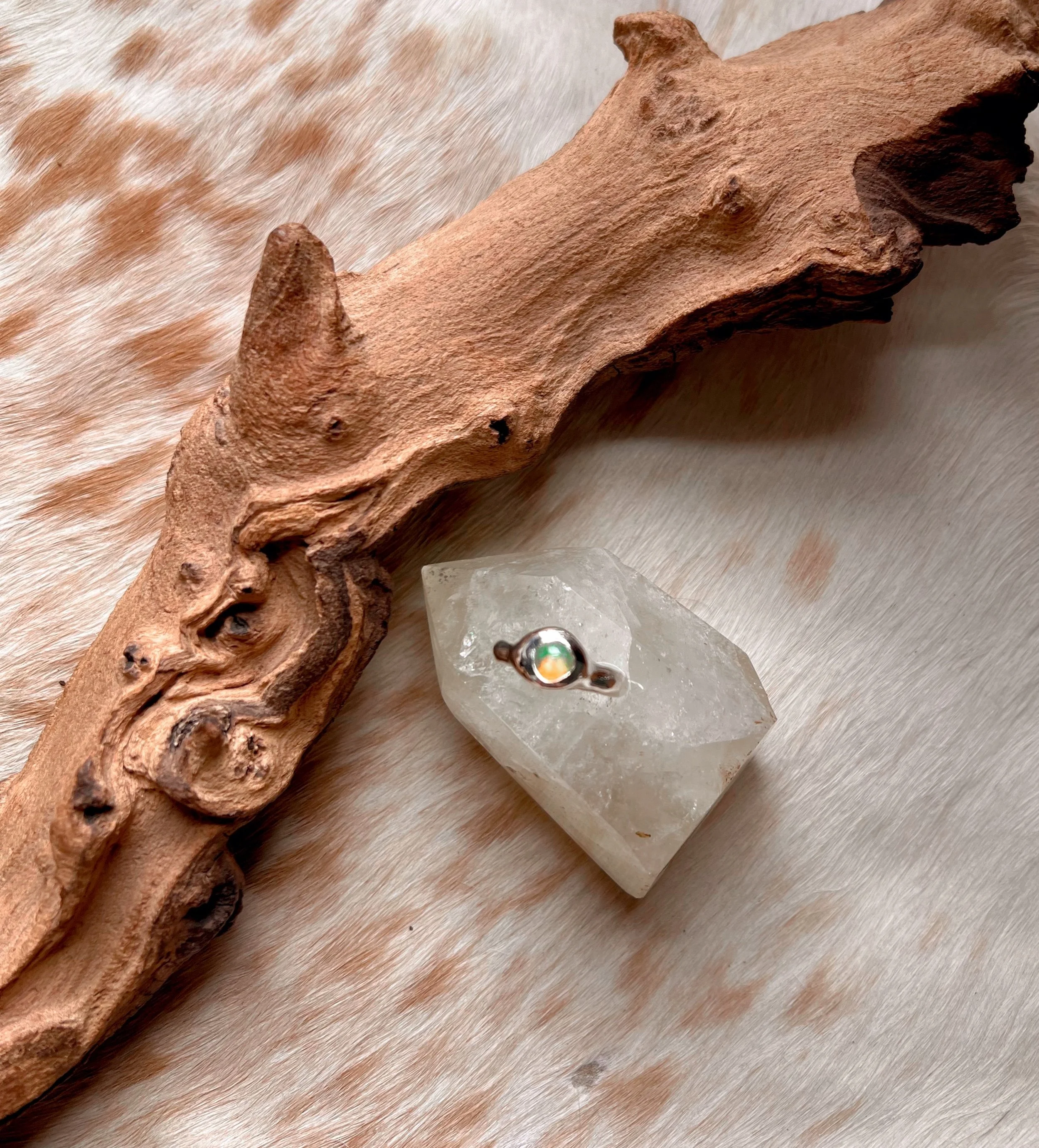 Signet-style sterling silver ring with a subtle, hand-carved texture and topped with an opal.