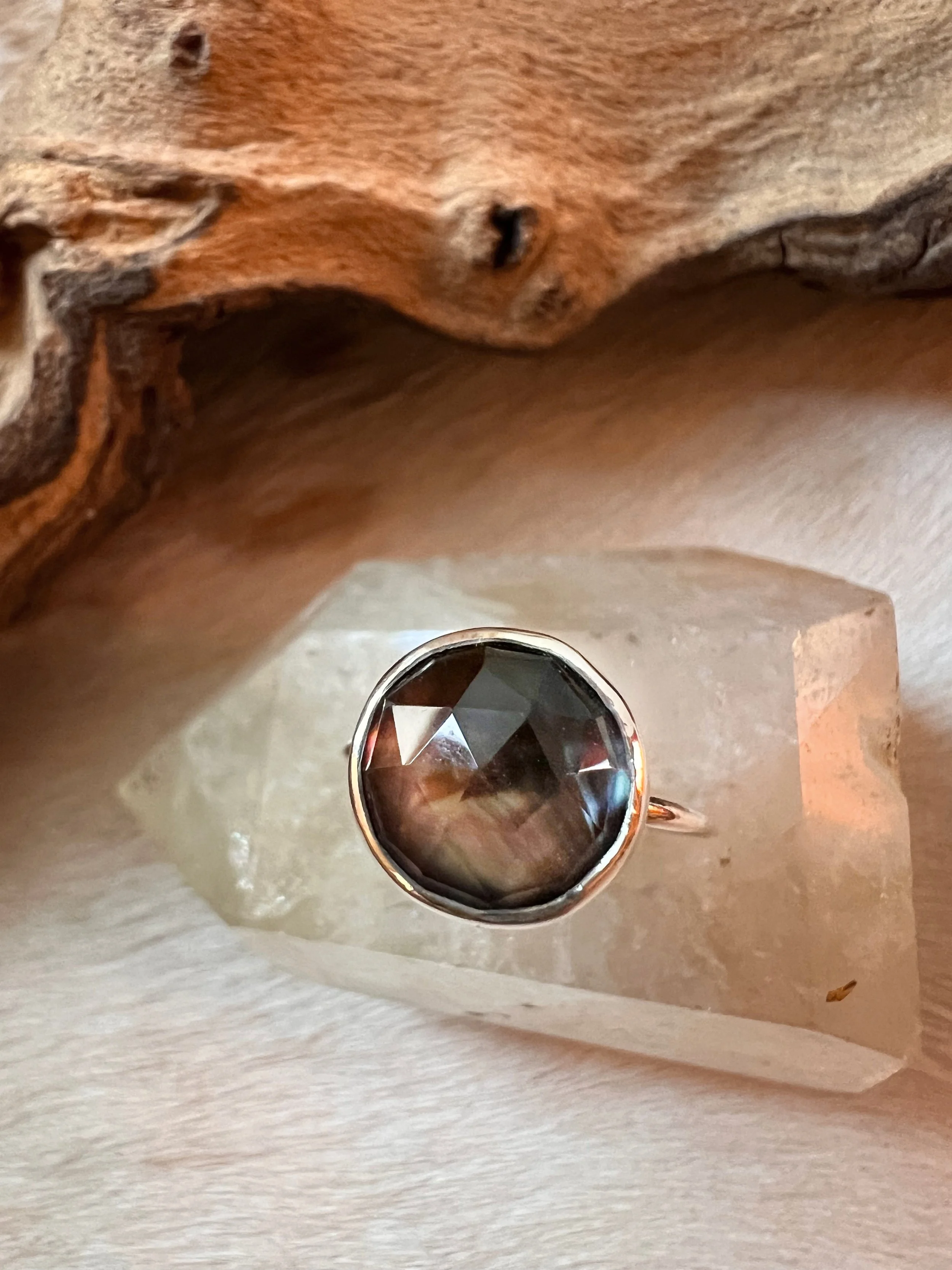 Sterling silver ring with a bezel-set faceted mother of pearl