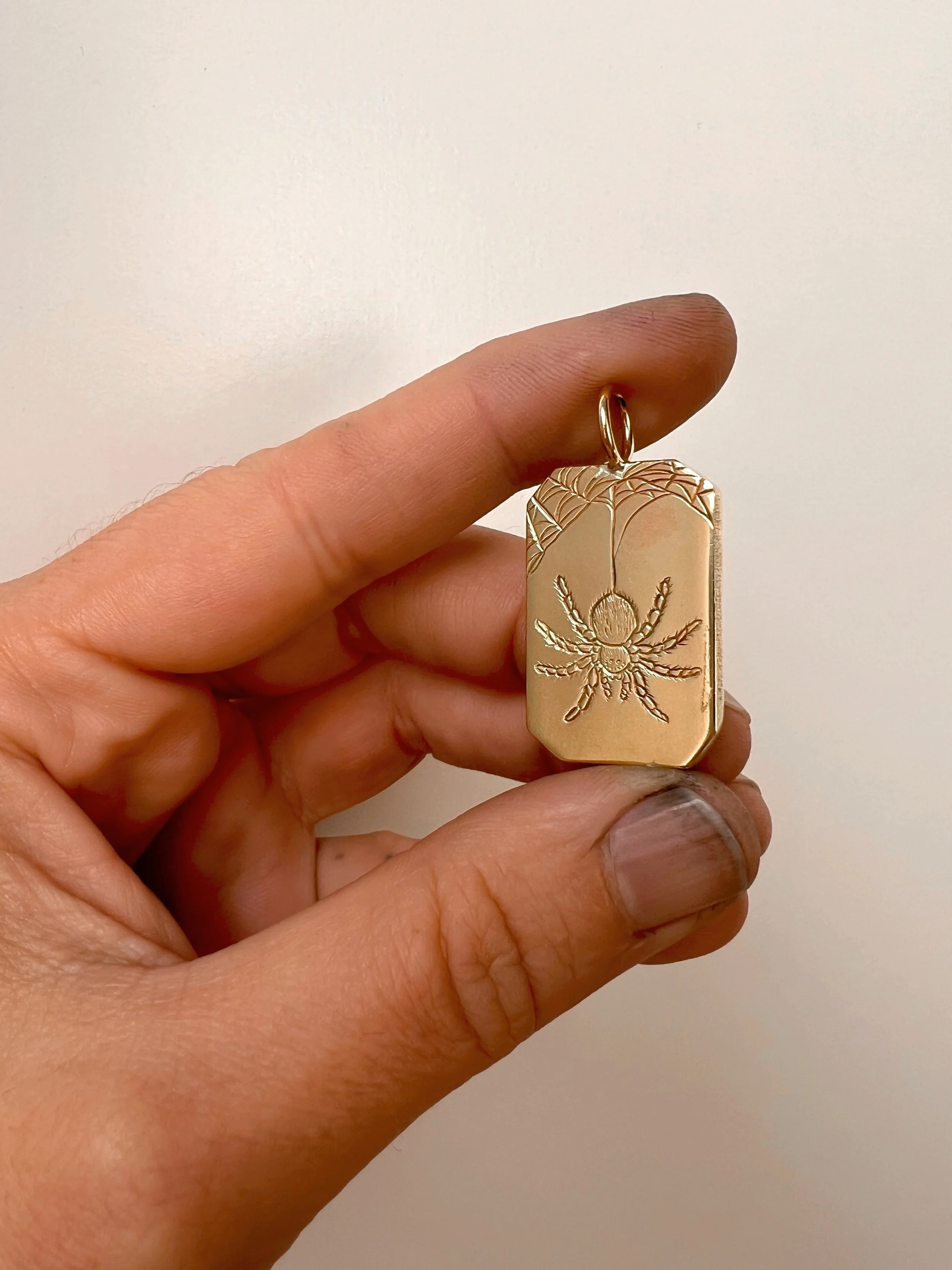 engraved brass spider pendant