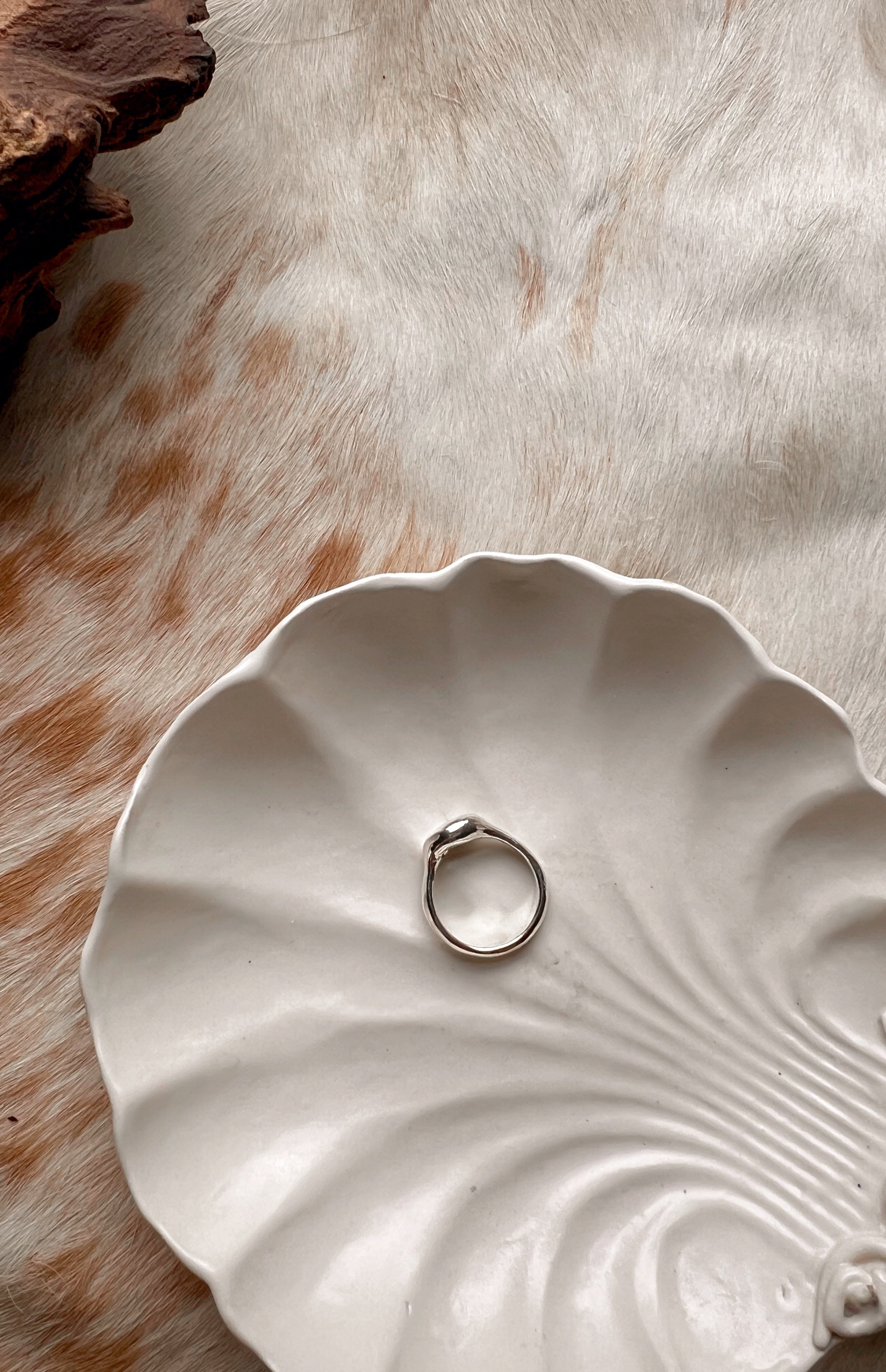 Signet-style sterling silver ring with a subtle, hand-carved texture and topped with an opal.