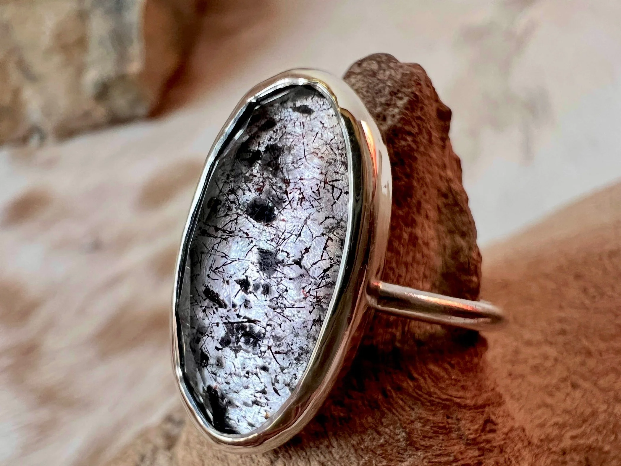Sterling silver ring with a bezel-set faceted black tourmalated quartz.
