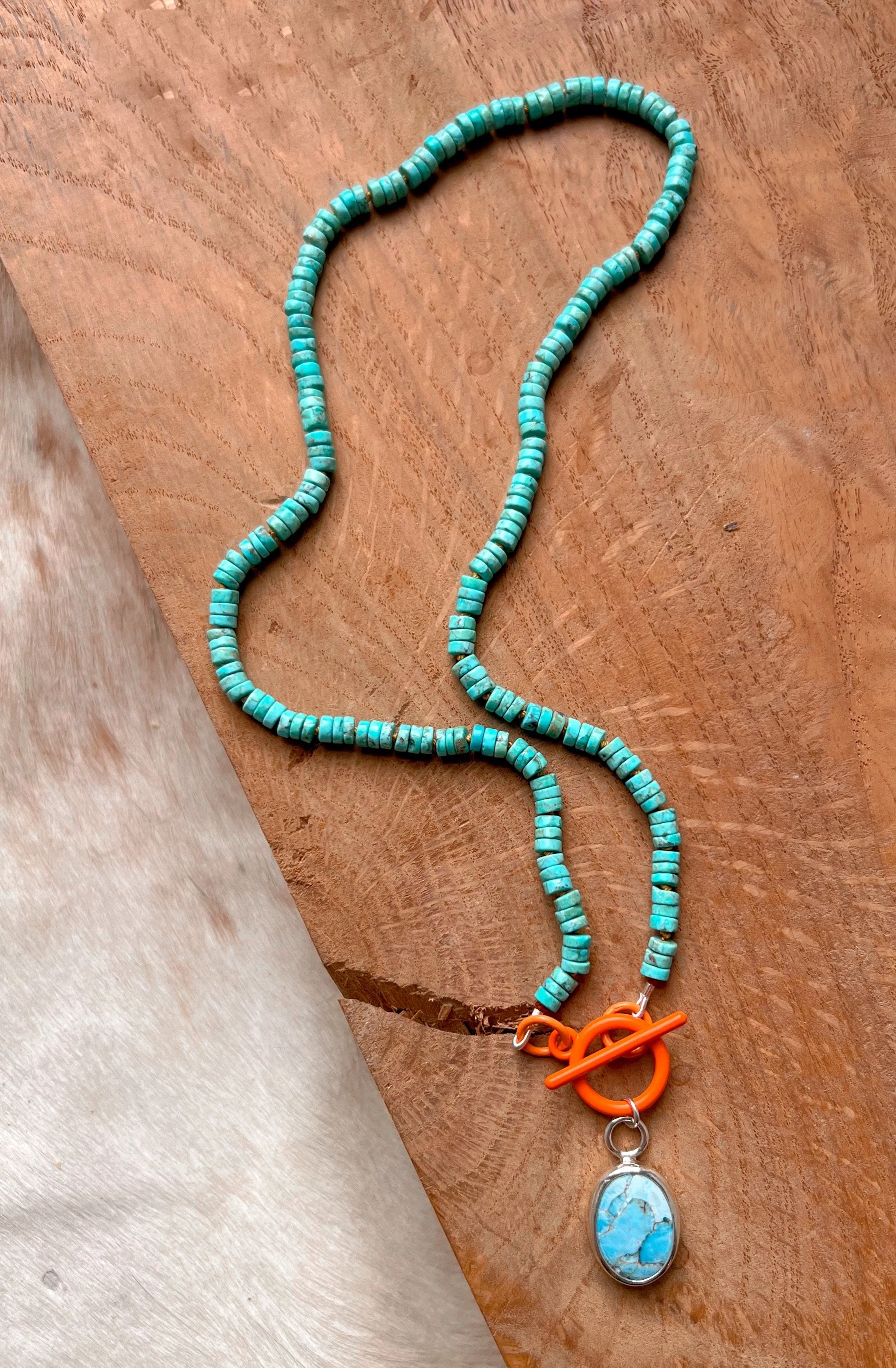 Turquoise beaded necklace with a blue azurite stone on the front