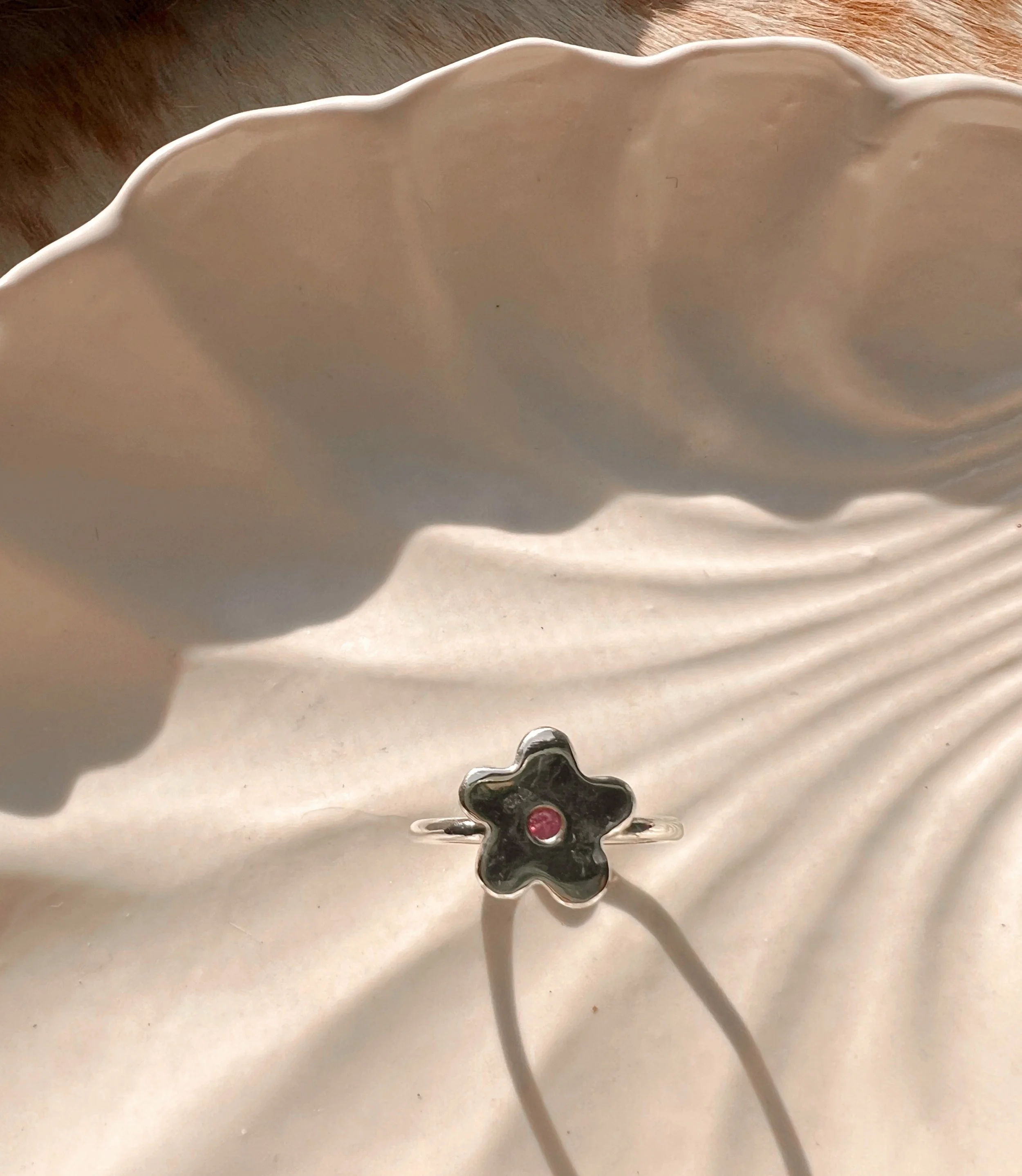 Pink Sapphire center set in a sterling silver flower , ring
