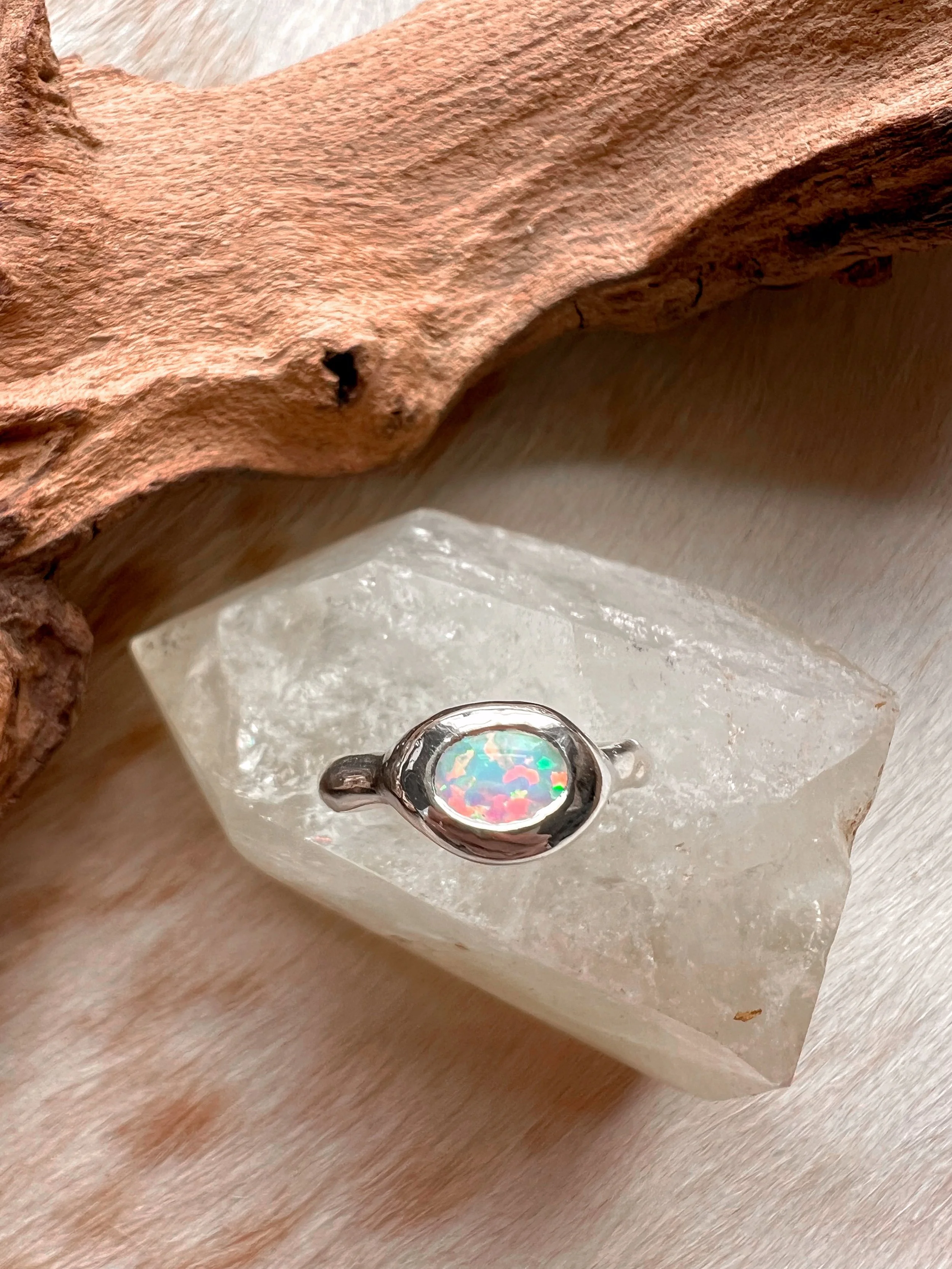 Signet-style sterling silver ring with a subtle, hand-carved texture and topped with an opal.