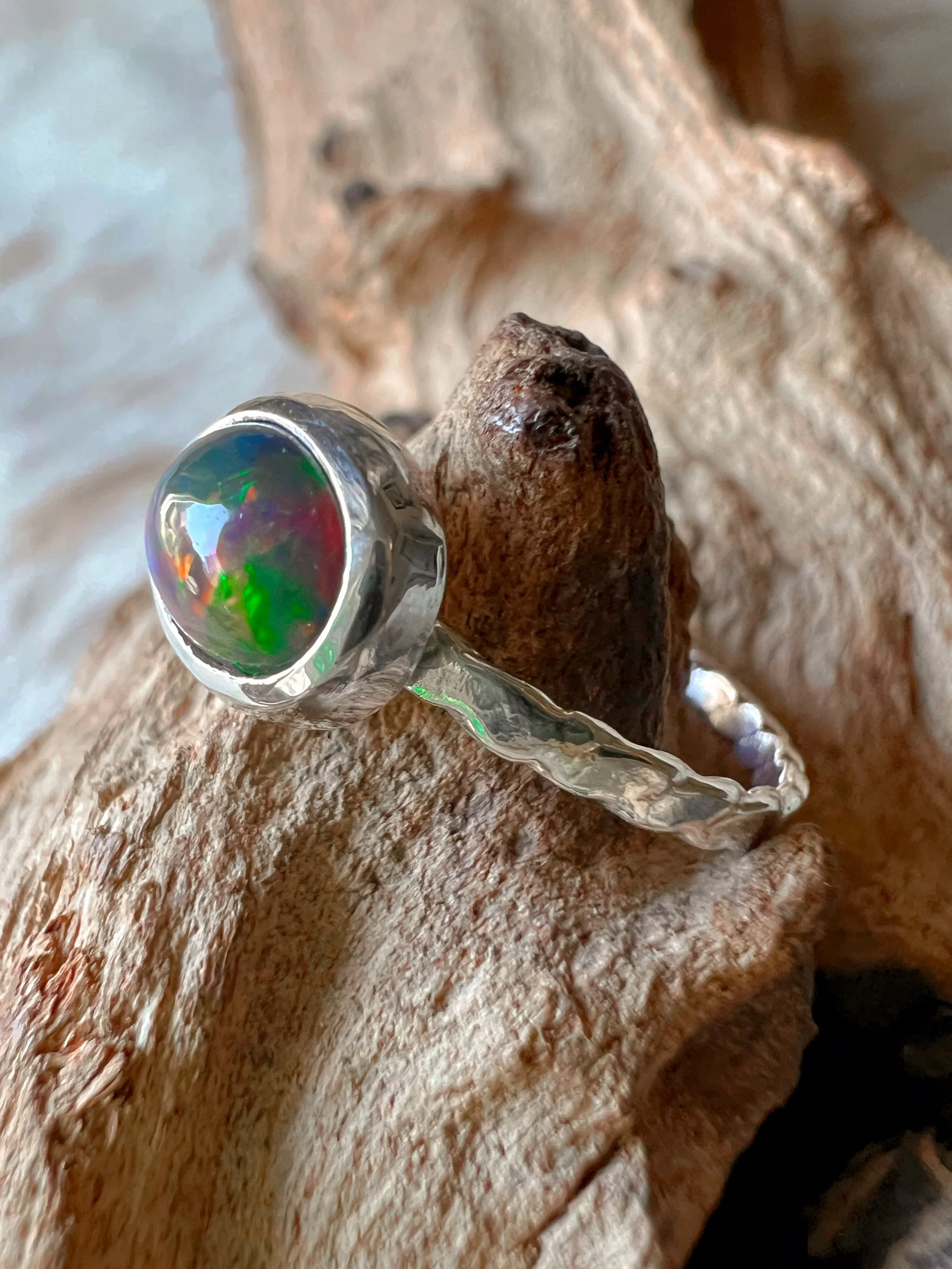 Sterling silver ring with a bezel-set opal