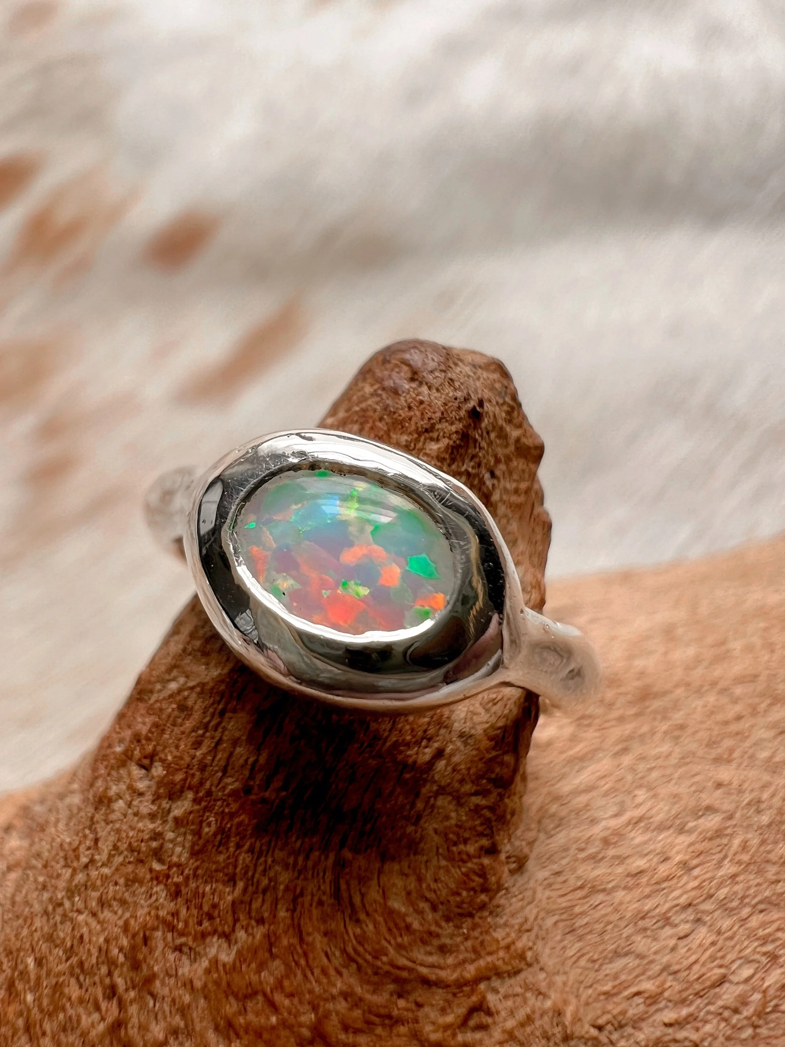 Signet-style sterling silver ring with a subtle, hand-carved texture and topped with an opal.