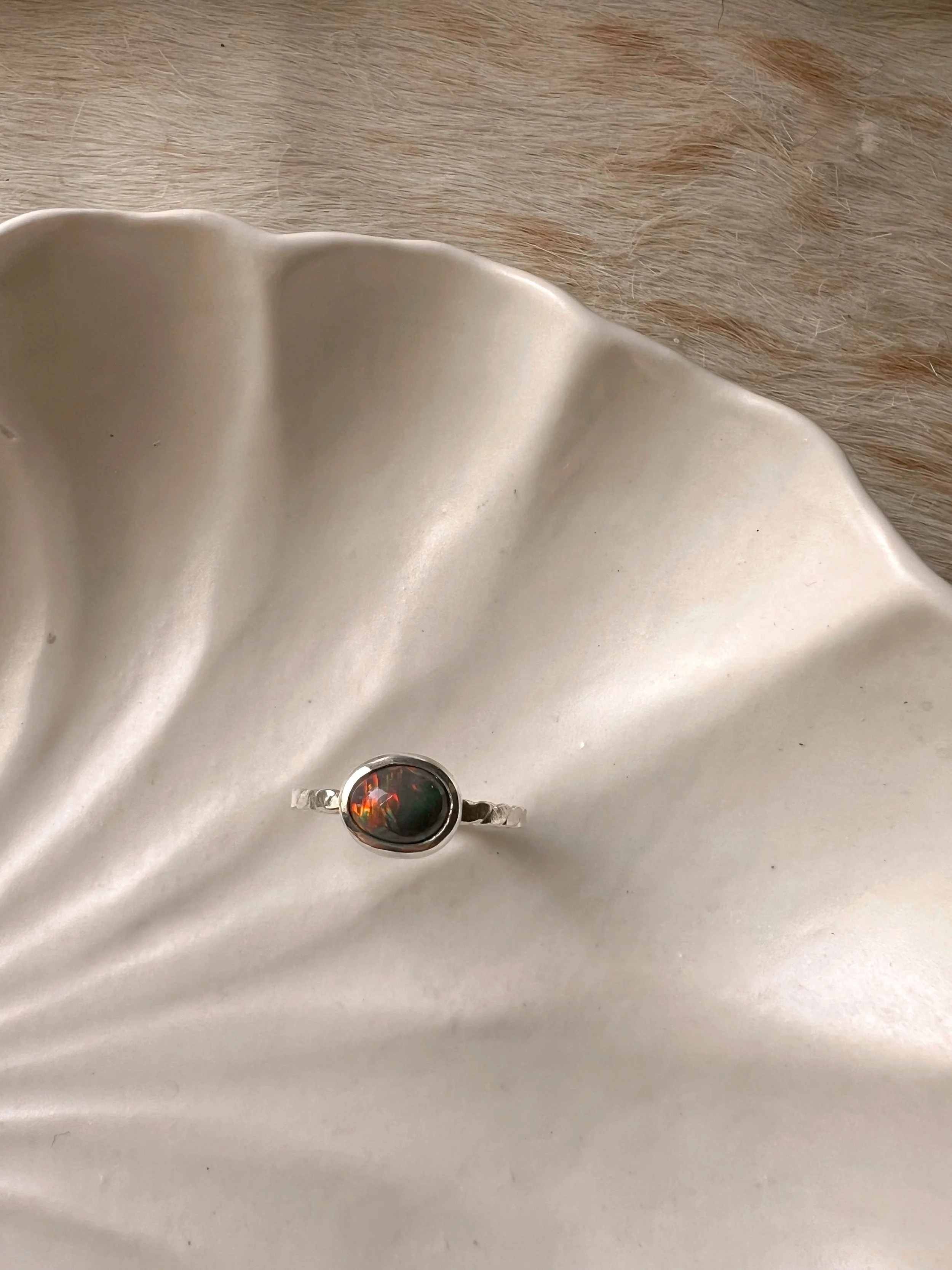 Sterling silver ring with a bezel-set opal