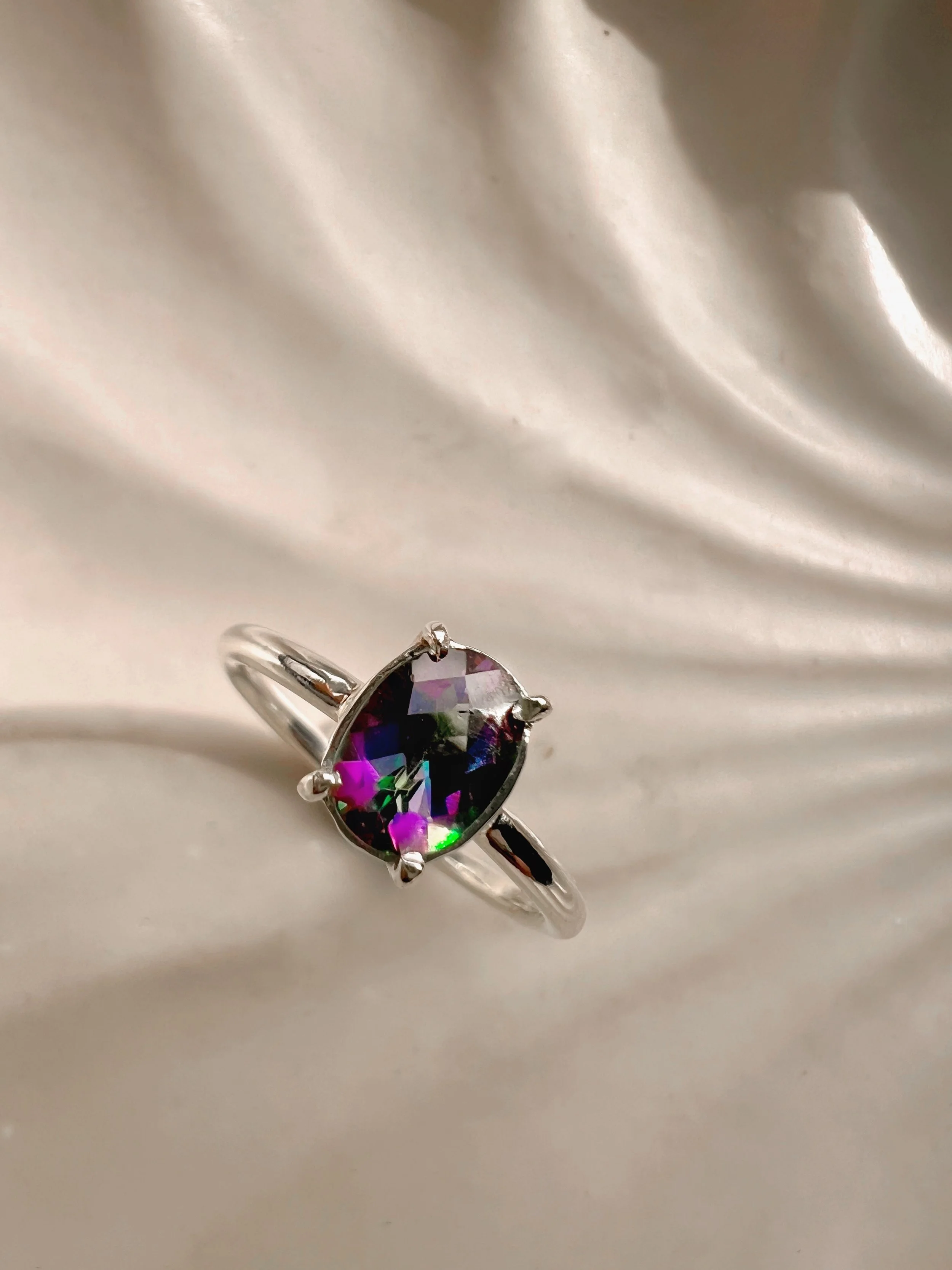 Rainbow Topaz set in a sterling silver claw setting