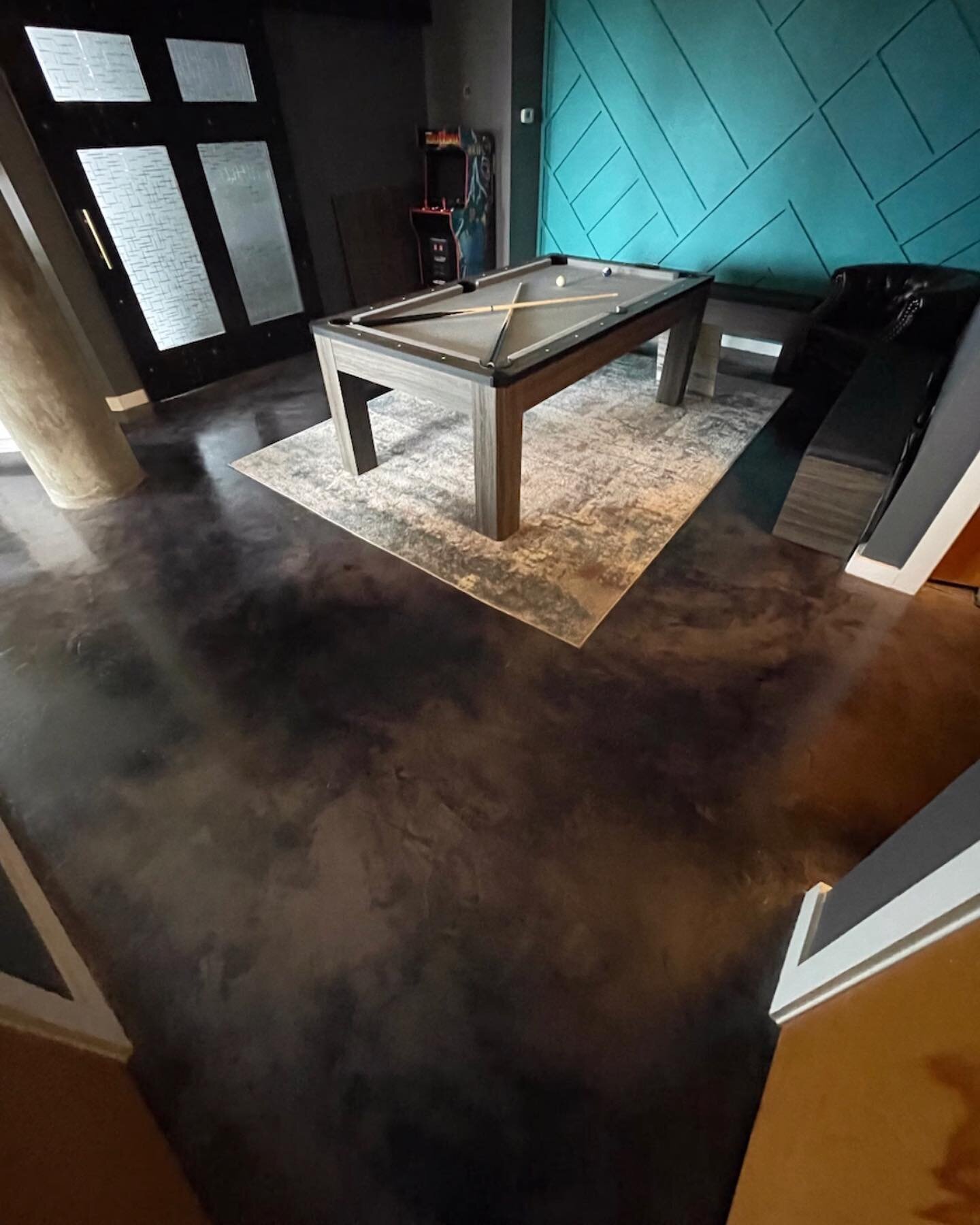 Stained concrete showcasing its minimalistic raw beauty while complementing this bold interior Atlanta loft.