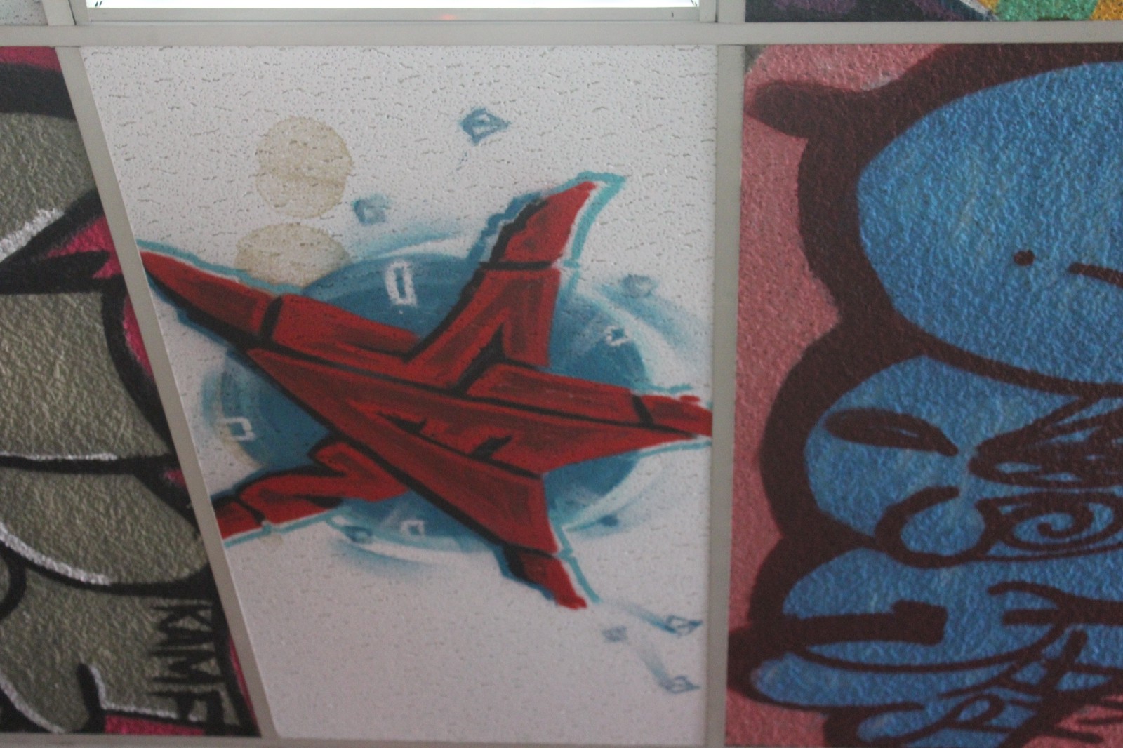 Sienide’s star tag on the ceiling of Tuff City Tattoo Parlor on East Fordham Road. The star, formed by the letters “SIEN,” is identical to his arm tattoo.