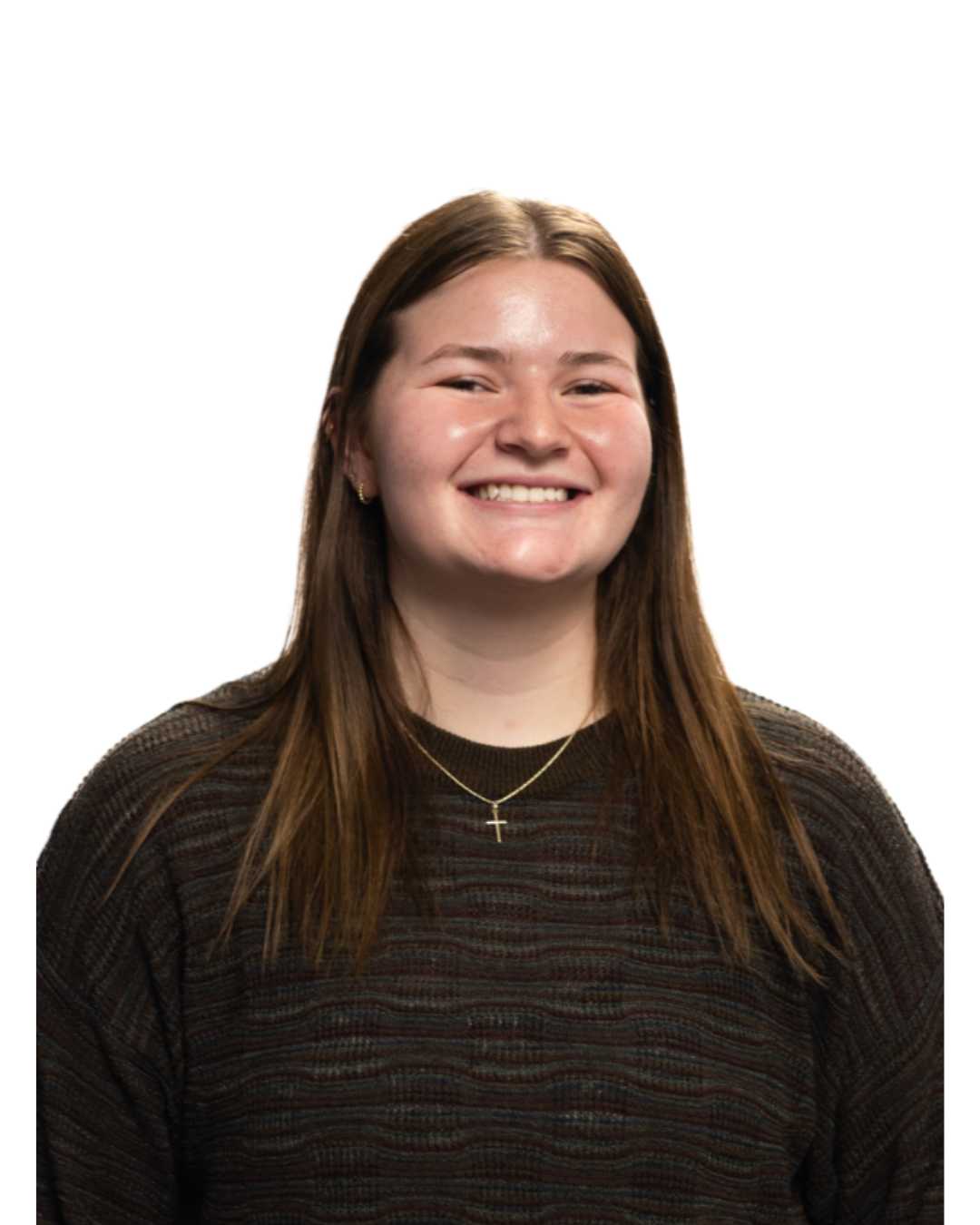 A smiling young woman with long brown hair, wearing a black patterned sweater and a gold necklace with a cross pendant.