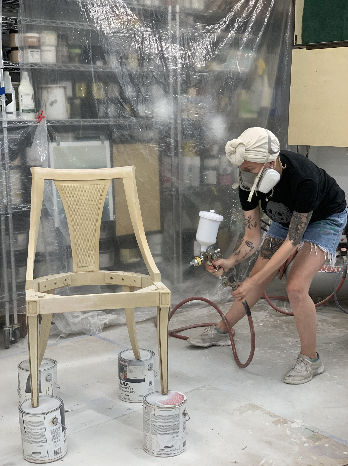spraying paint on chairs