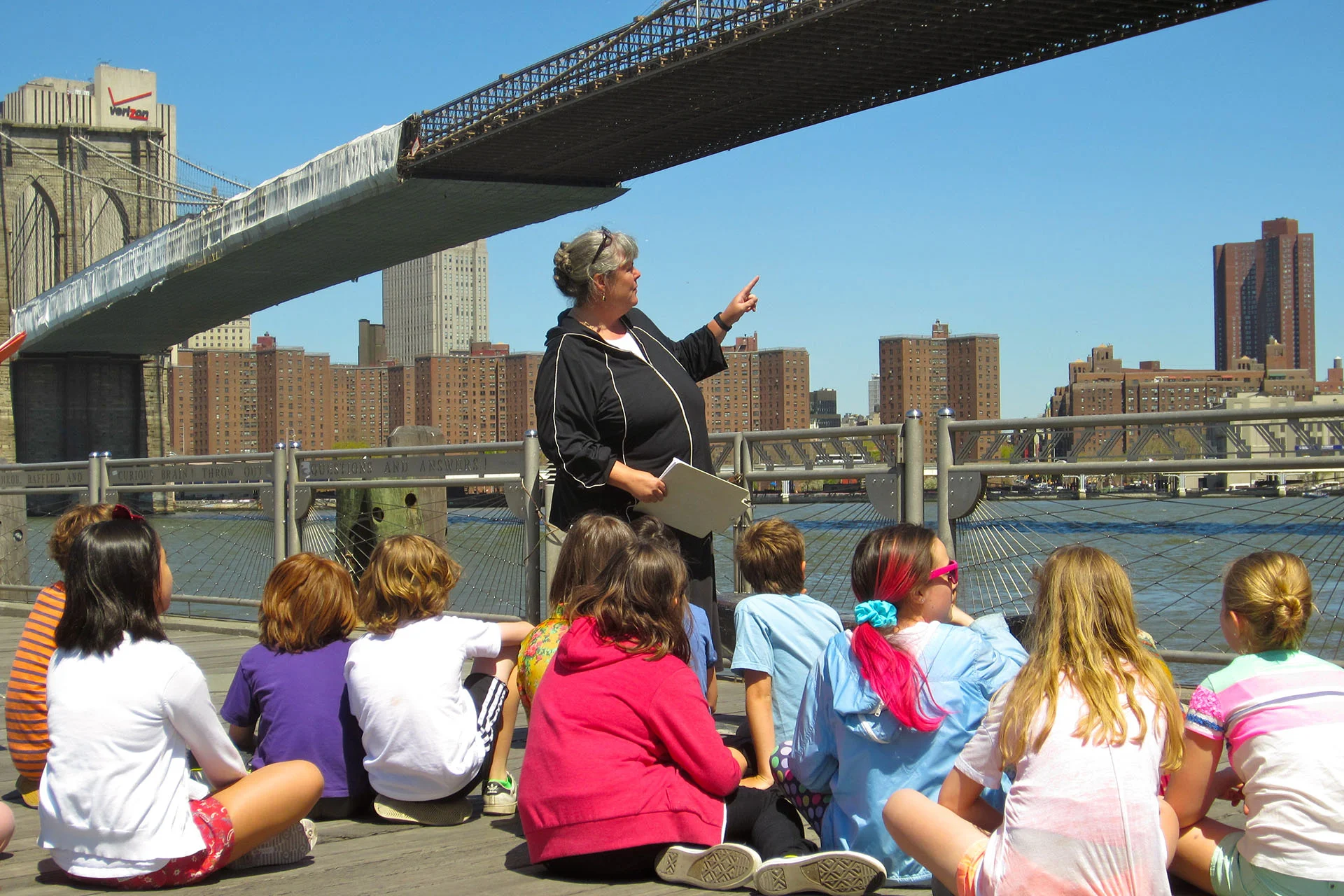 Sarah Richards teaching her fifth graders under the Brooklyn Bridge.