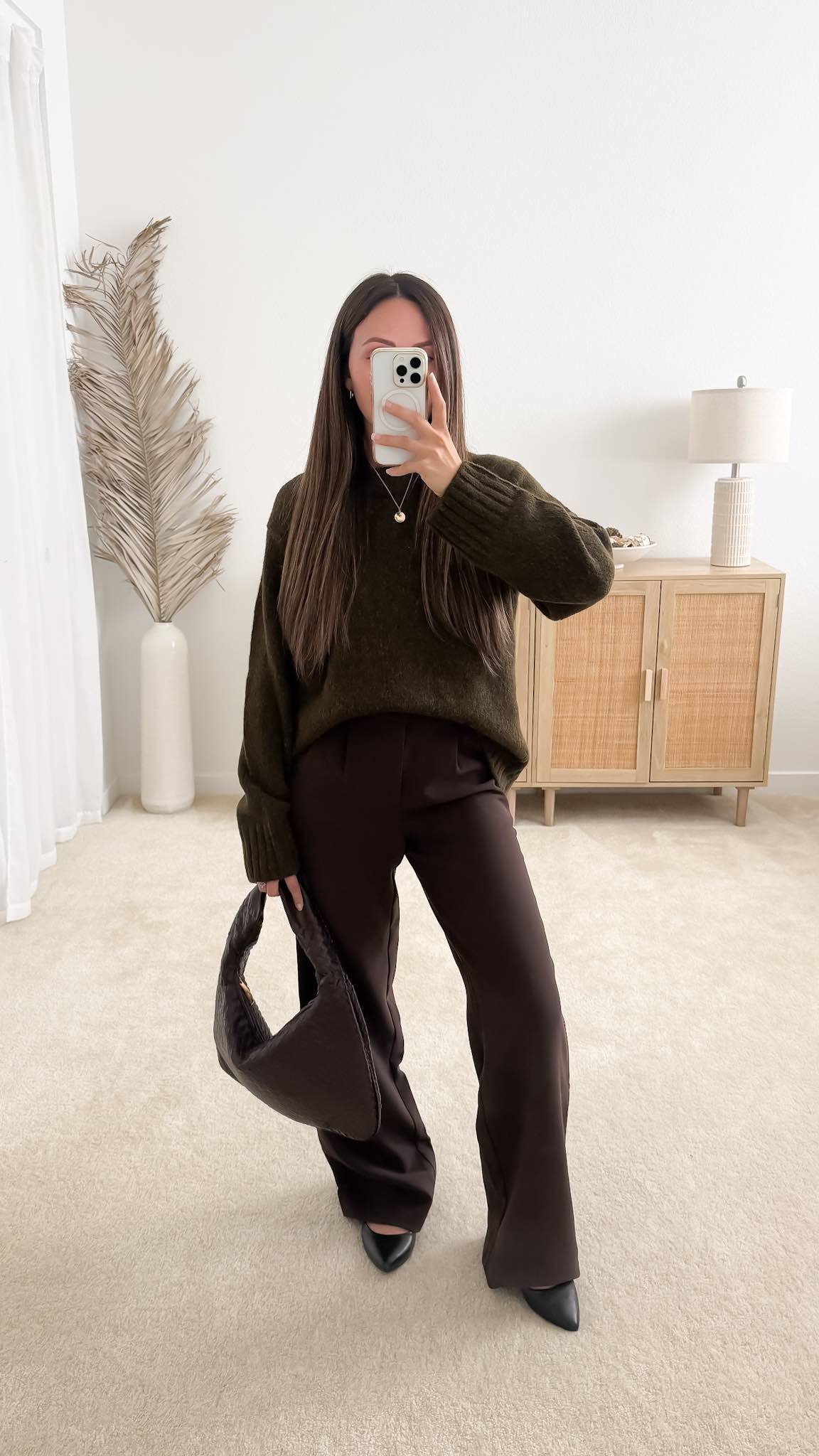 Sweater with trousers outfit featuring the Quince Lofty Baby Alpaca Oversized Crew Sweater styled with brown pants, pointed heels, and a brown handbag