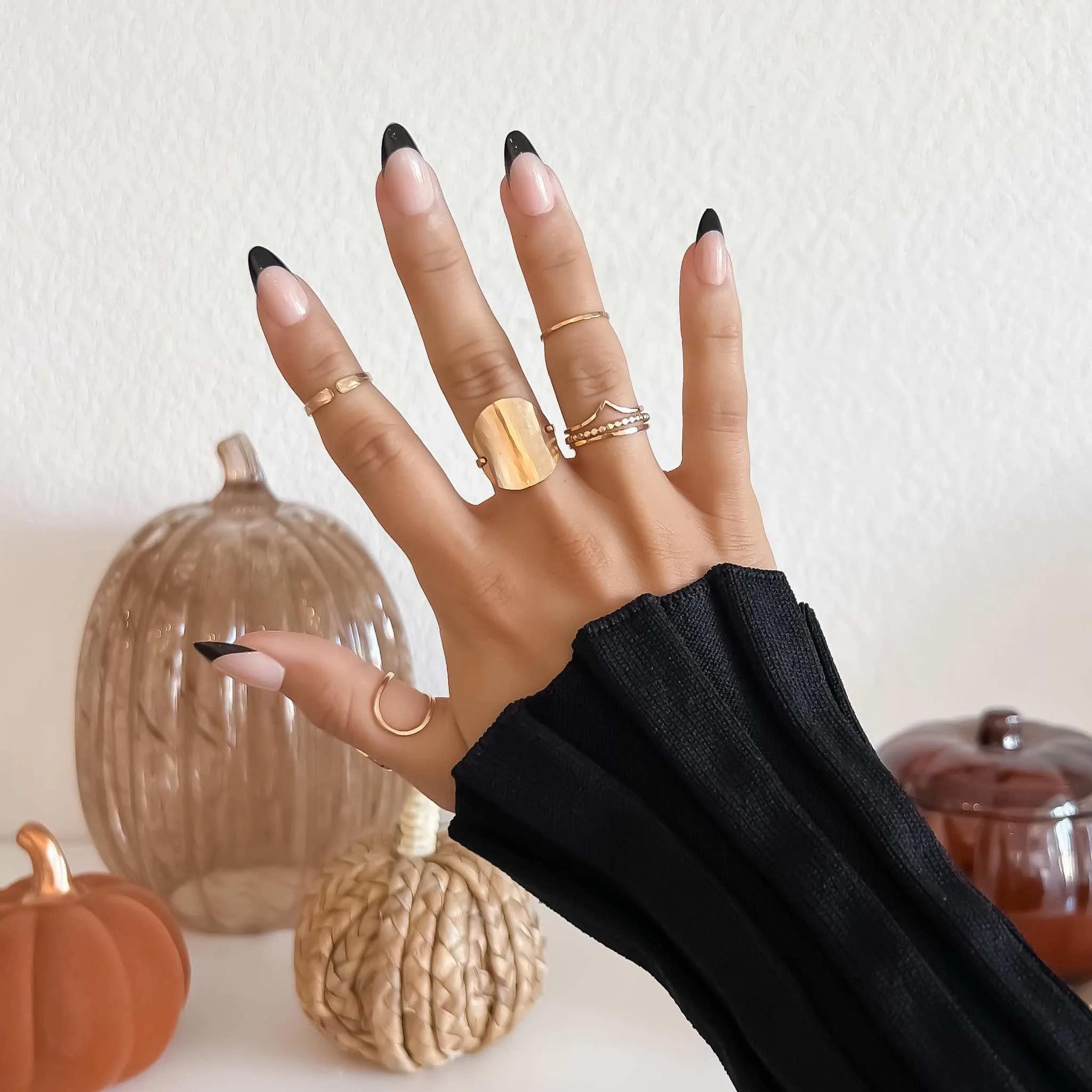 Neutral fall nails featuring black tip french manicure and minimalist fall decor background 