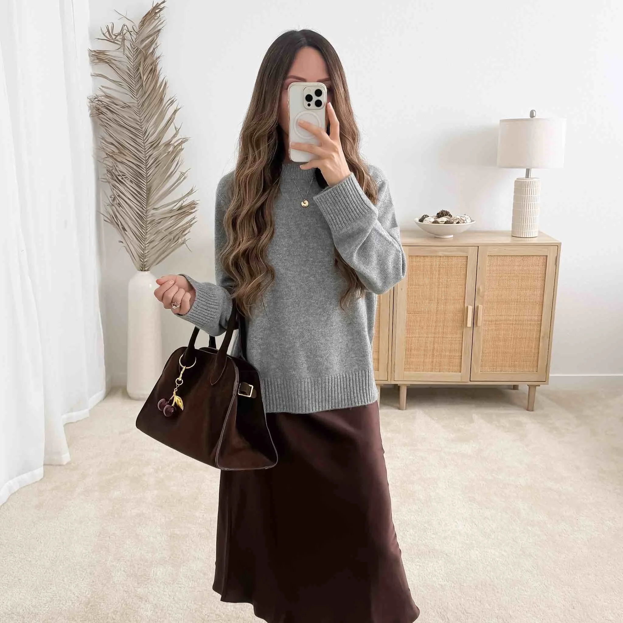  Chic neutral fall outfit styled with capsule wardrobe essentials for fall: grey sweater, brown satin midi skirt, suede tote 