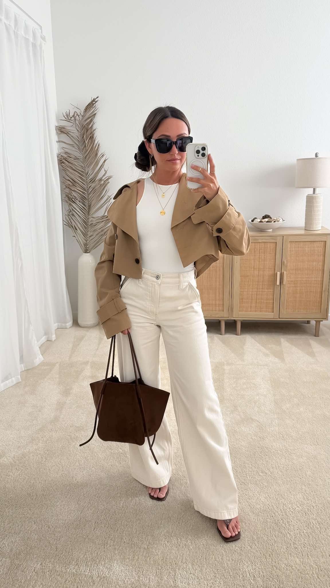 Cropped trench coat outfit styled with a white tank top and white wide-leg jeans