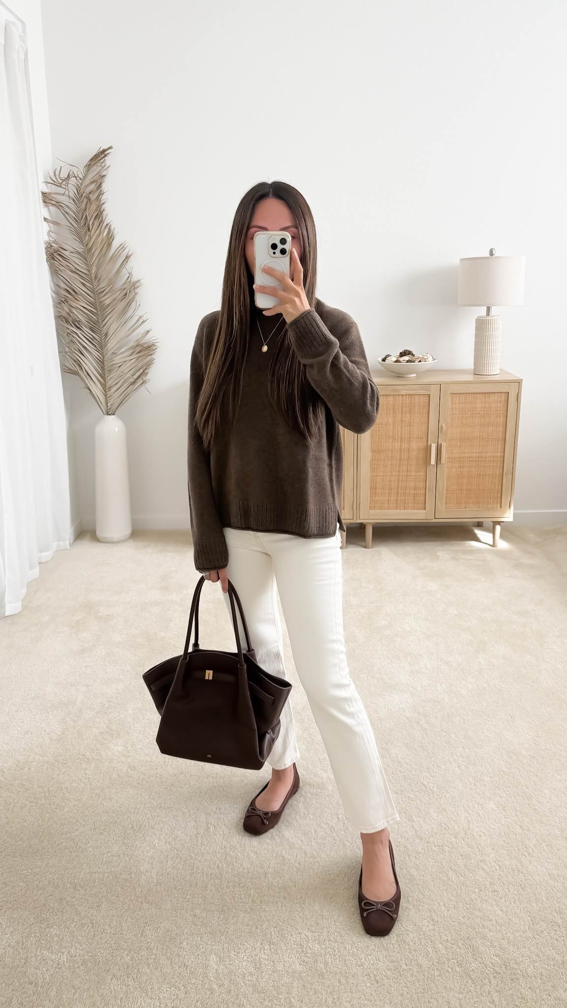 Sweater outfit featuring the Quince Mongolian Cashmere Boxy Crewneck Sweater styled with white jeans, brown ballet flats, and a brown handbag