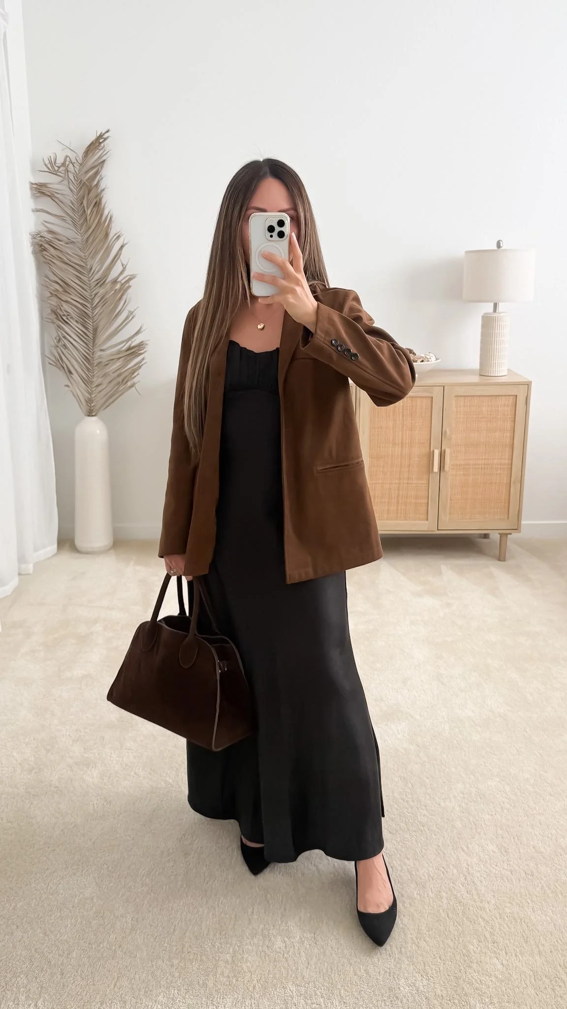 Brown suede blazer layered over a black maxi dress with black heels for a dressy fall outfit.