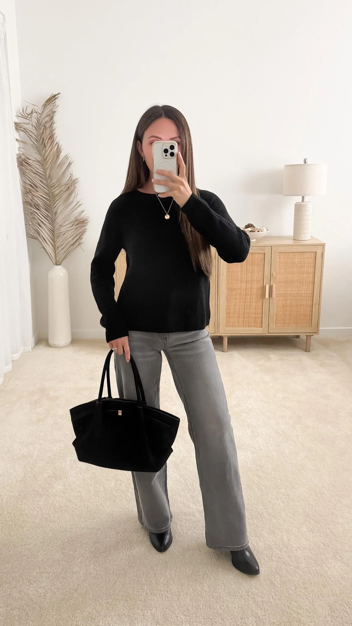 Sweater with jeans outfit featuring the Quince Mongolian Cashmere Fisherman Crewneck Sweater styled with gray straight-leg jeans, black ankle boots, and a black suede tote