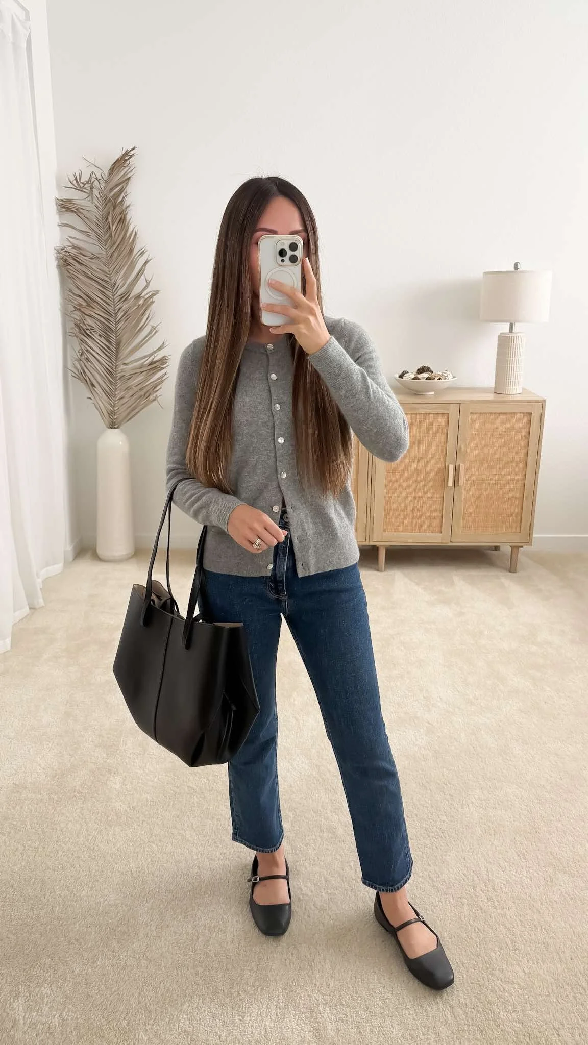 Fall outfit with gray cardigan, dark wash jeans, black ballet flats and black tote bag