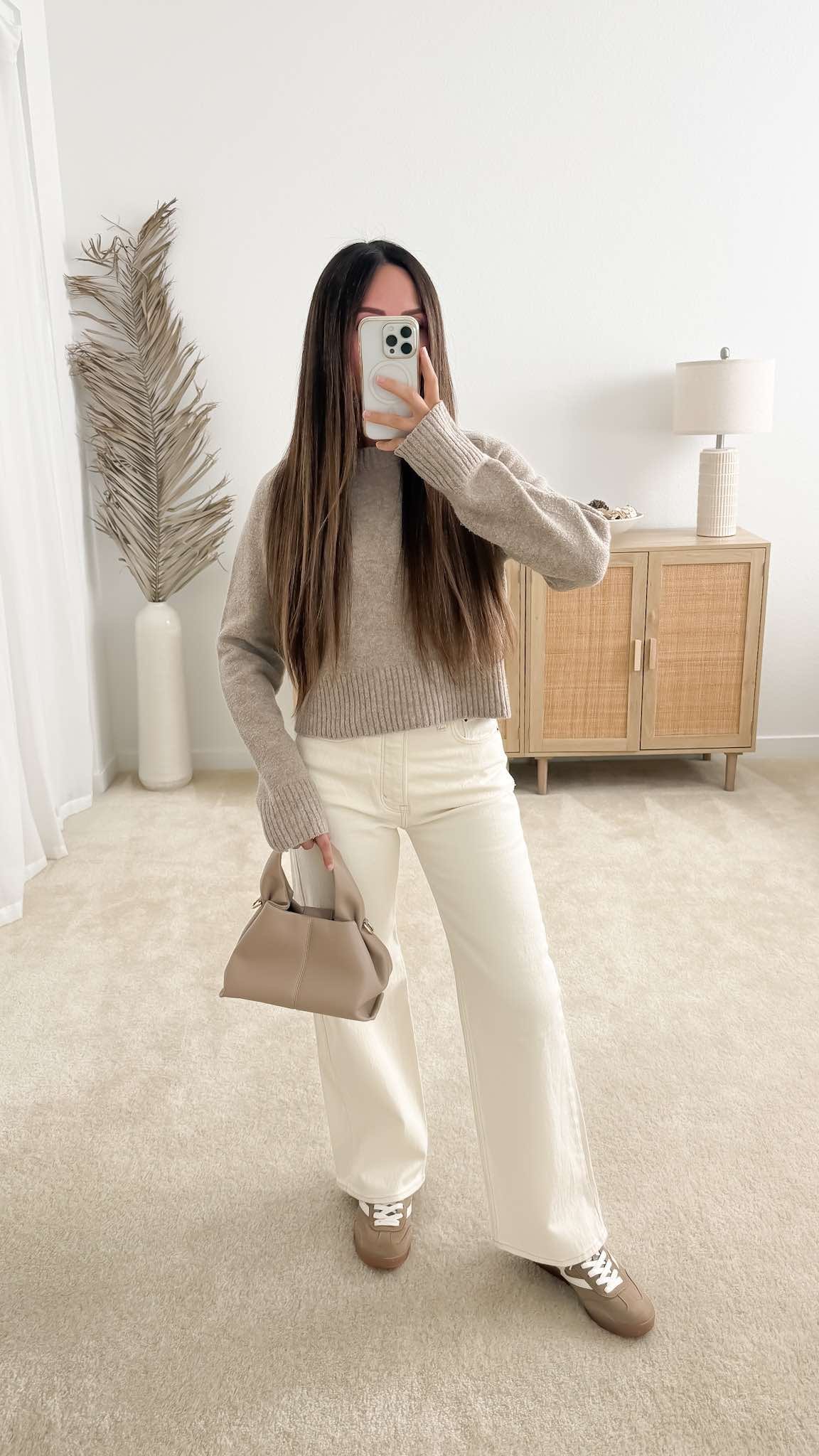 Neutral fall outfit with beige sweater, white wide leg jeans, taupe bag and sneakers